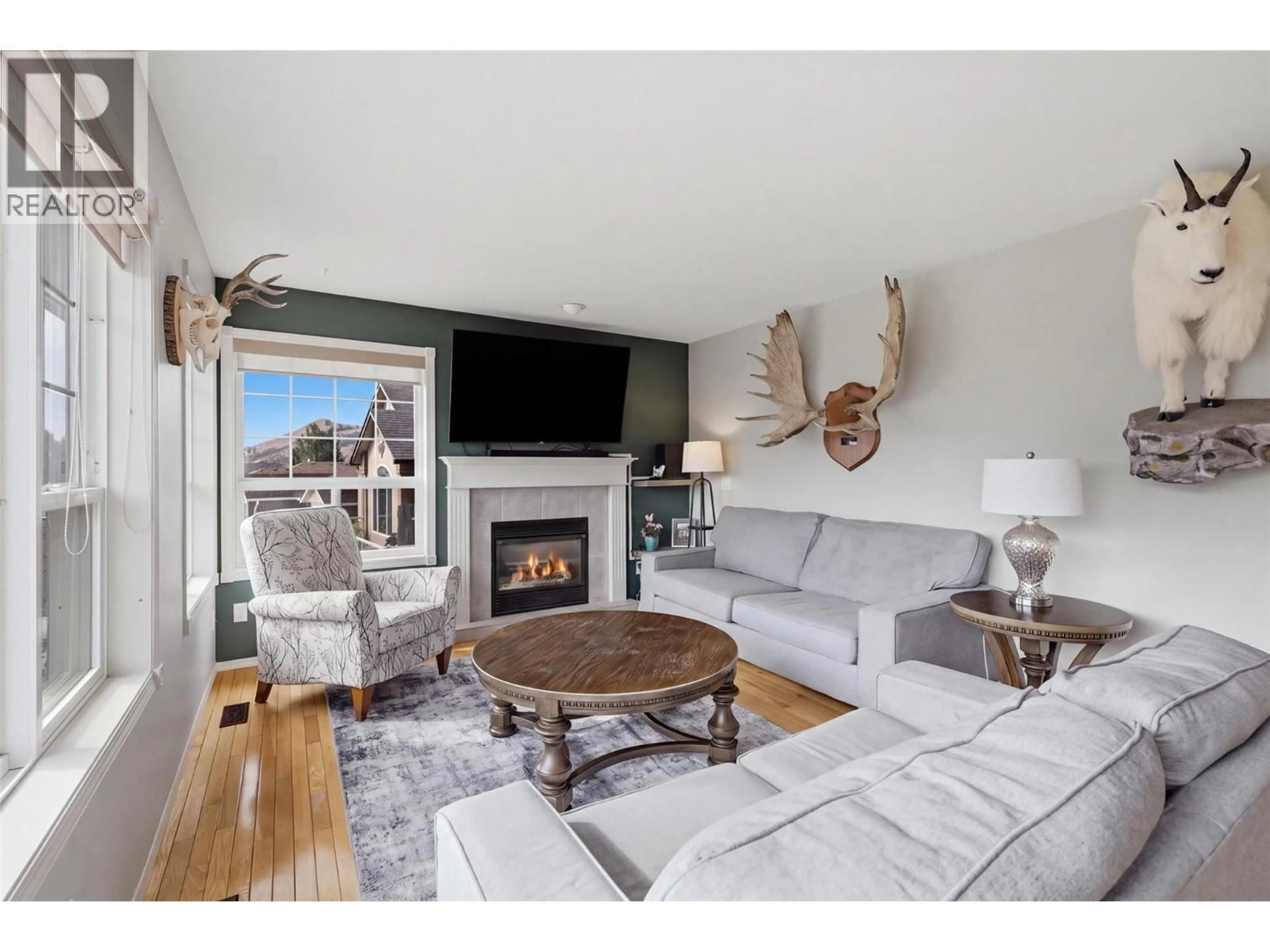 Living room with furniture, wood/laminate floor for 992 PINE SPRINGS ROAD, Kamloops British Columbia V2B8H2