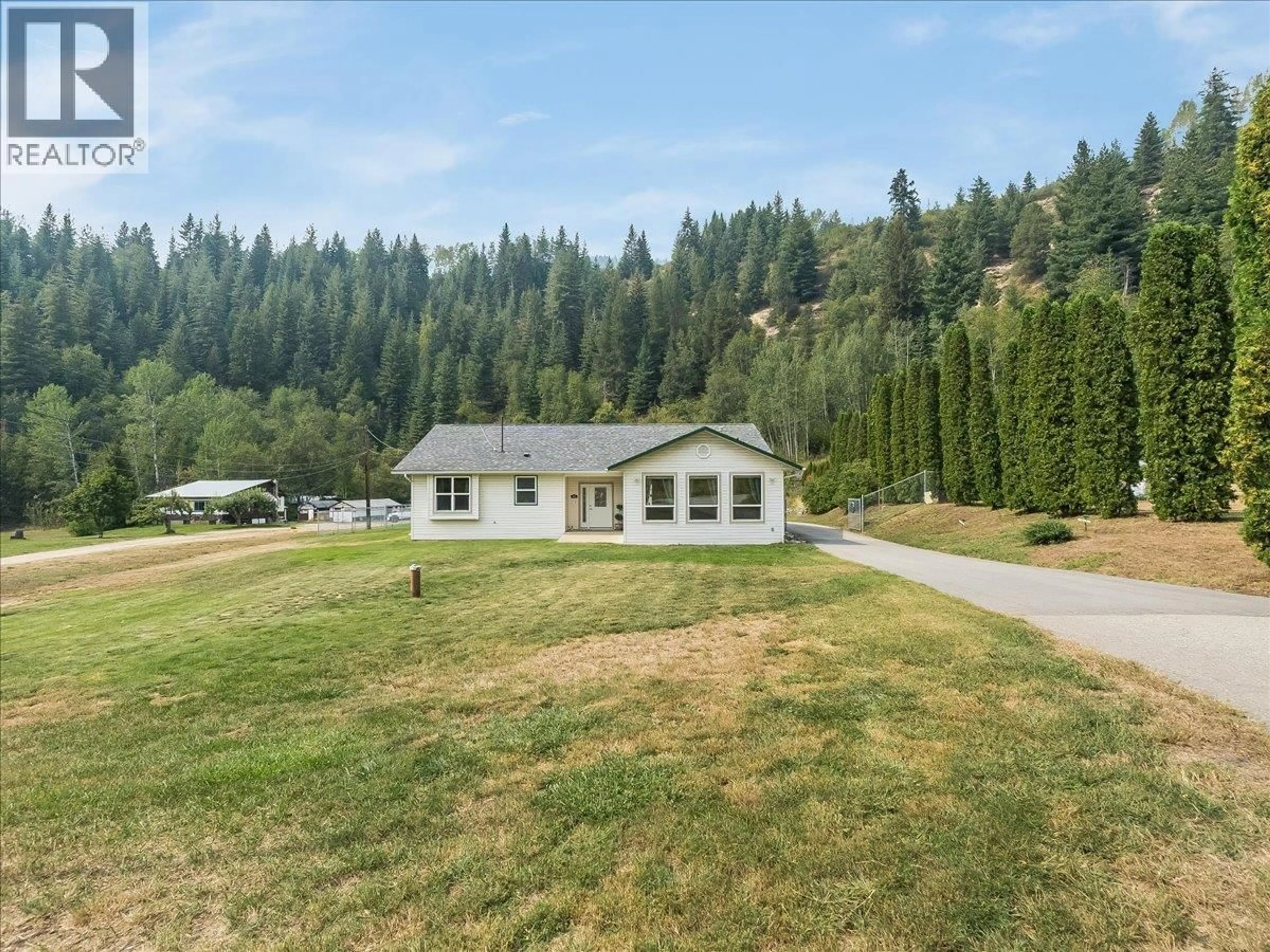 A pic from outside/outdoor area/front of a property/back of a property/a pic from drone, mountain view for 900 CHINA CREEK ROAD, Genelle British Columbia V0G1G0