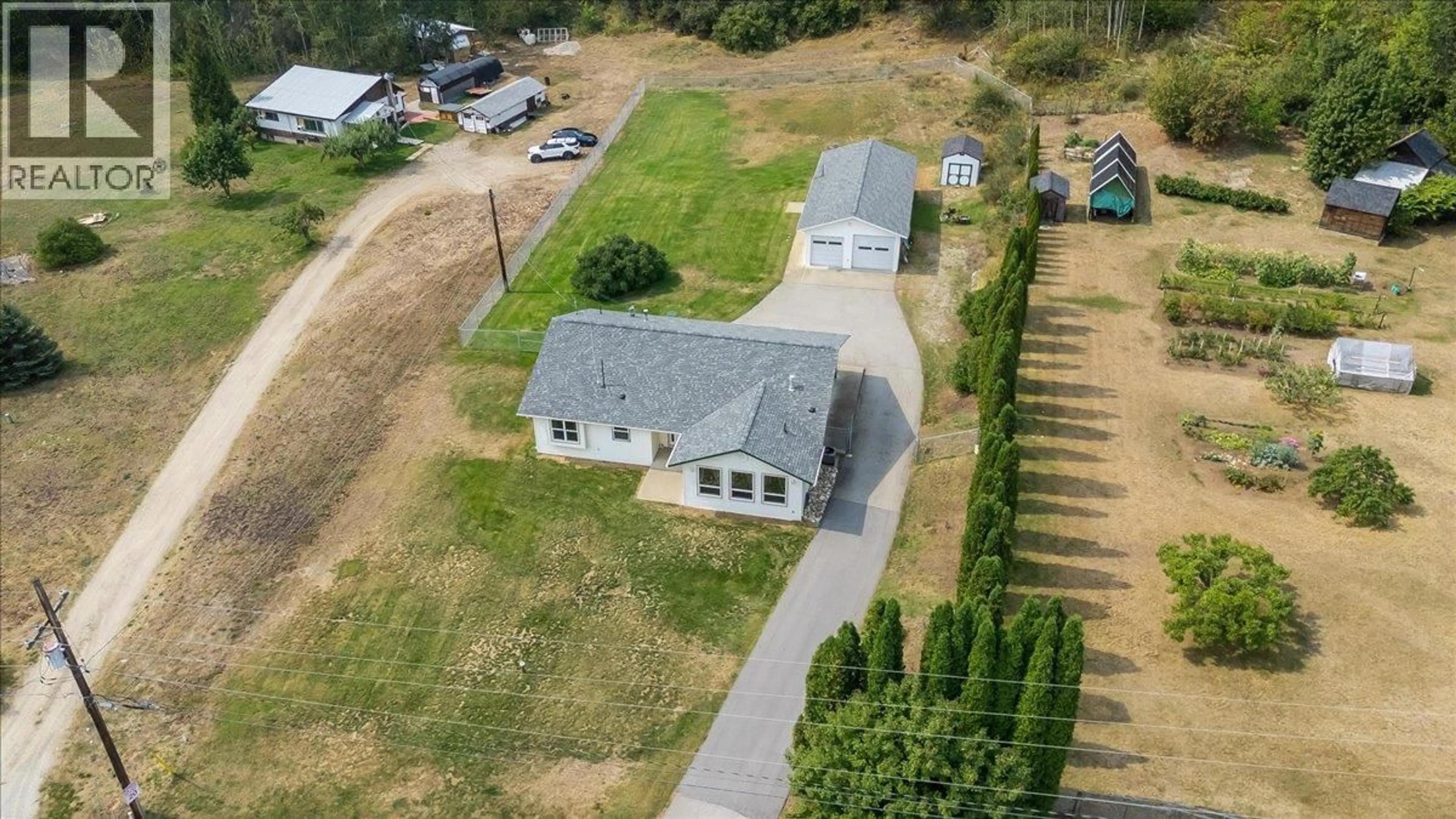 A pic from outside/outdoor area/front of a property/back of a property/a pic from drone, building for 900 CHINA CREEK ROAD, Genelle British Columbia V0G1G0