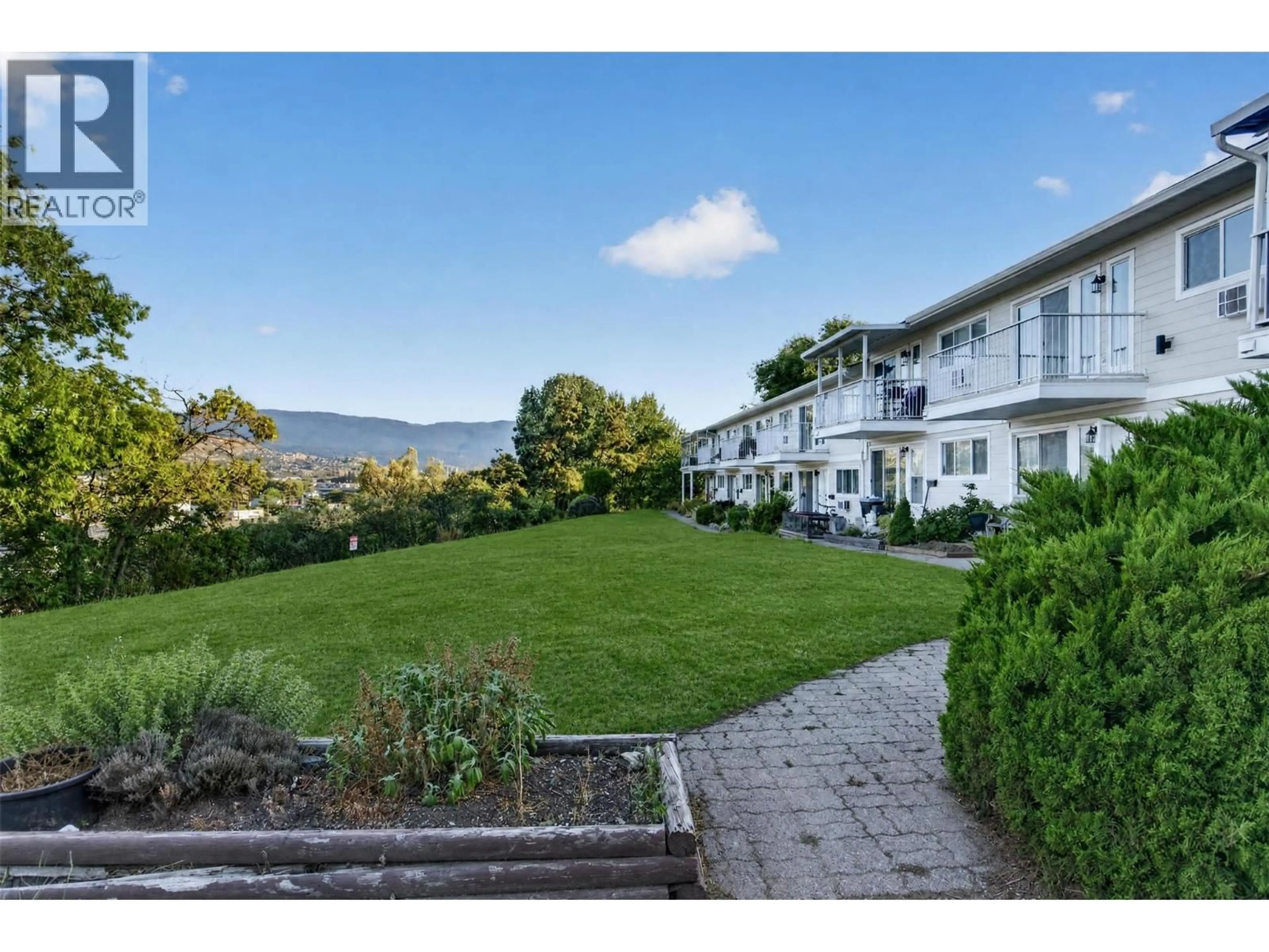A pic from outside/outdoor area/front of a property/back of a property/a pic from drone, mountain view for 206 - 4004 34 STREET, Vernon British Columbia V1T5Y2