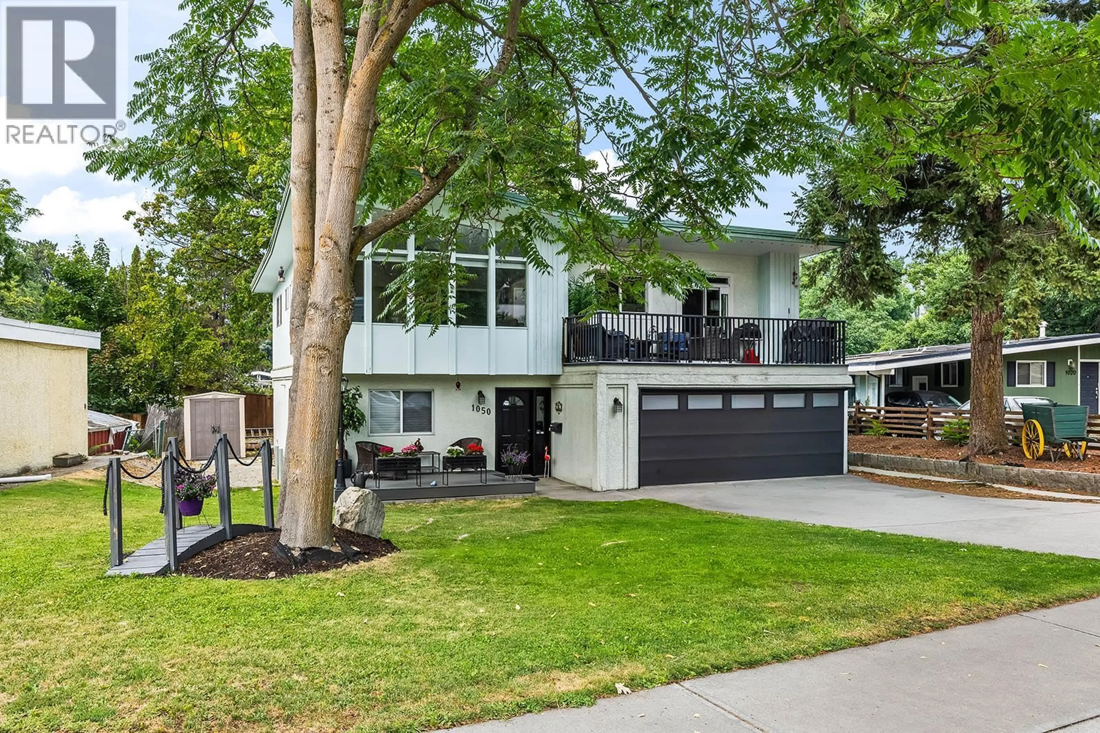 Home with vinyl exterior material, street for 1050 PINECREST LANE, Kelowna British Columbia V1Y4L3