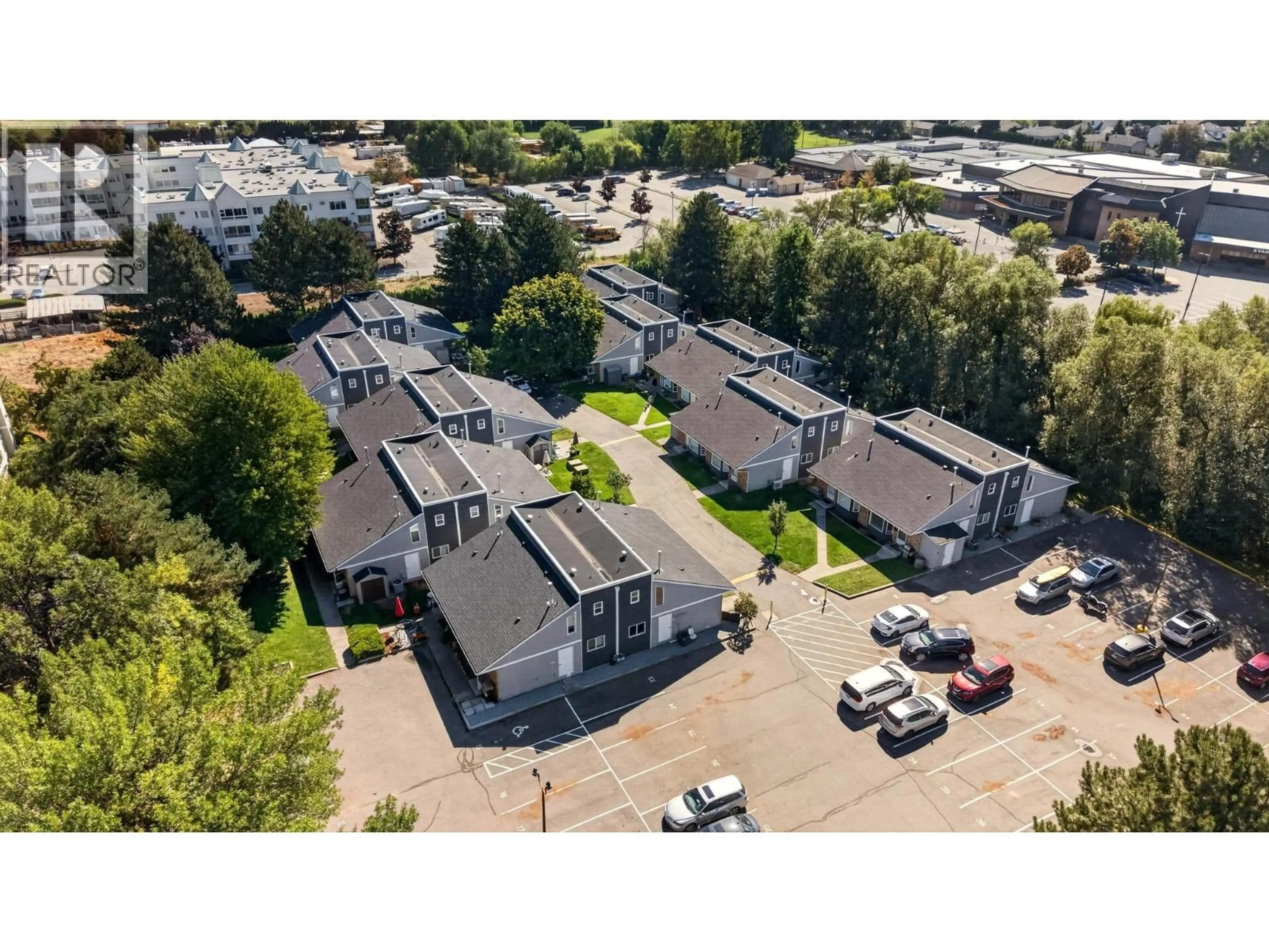 A pic from outside/outdoor area/front of a property/back of a property/a pic from drone, street for 104 - 3155 GORDON DRIVE, Kelowna British Columbia V1W3N5