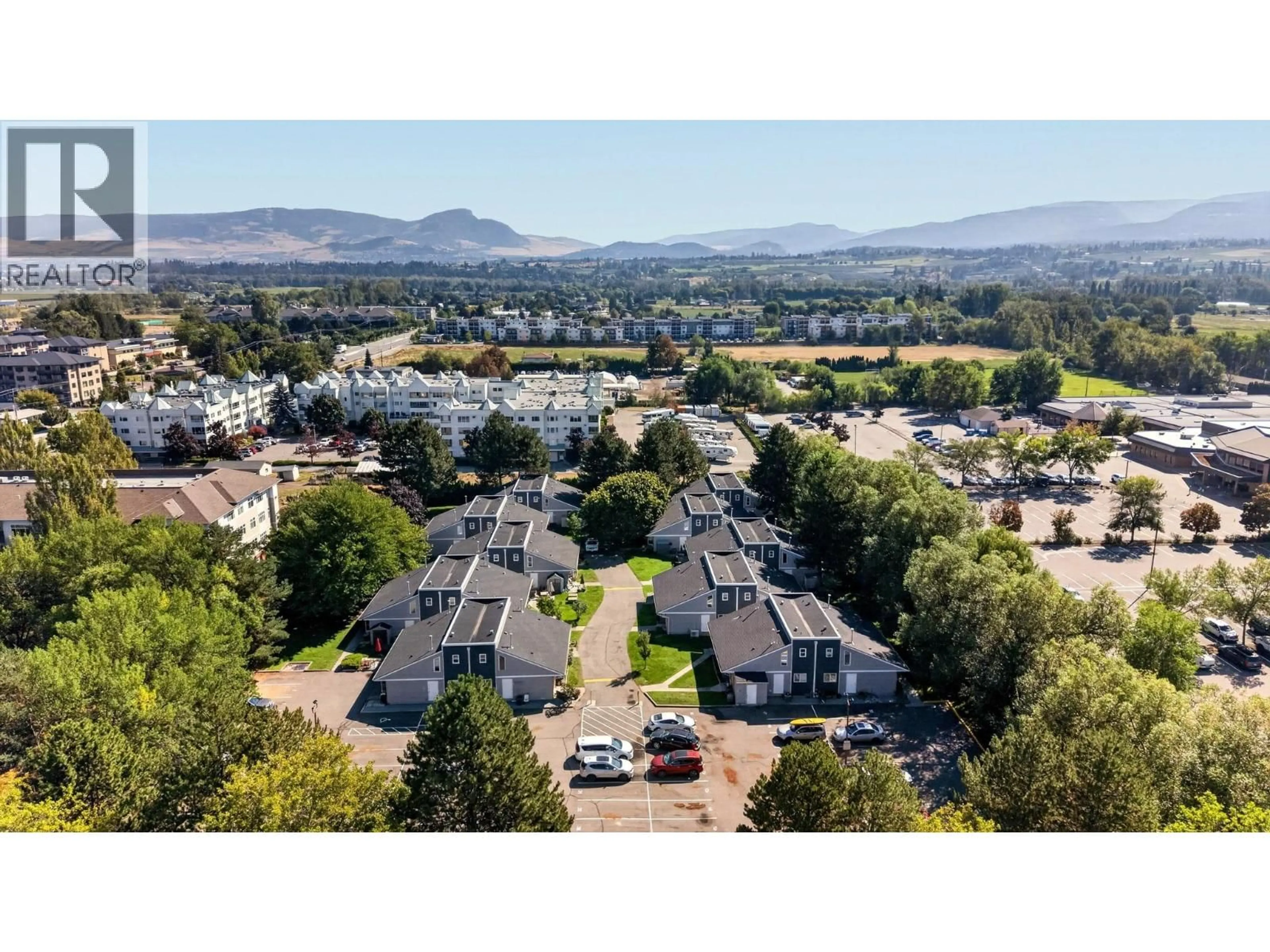 A pic from outside/outdoor area/front of a property/back of a property/a pic from drone, mountain view for 104 - 3155 GORDON DRIVE, Kelowna British Columbia V1W3N5