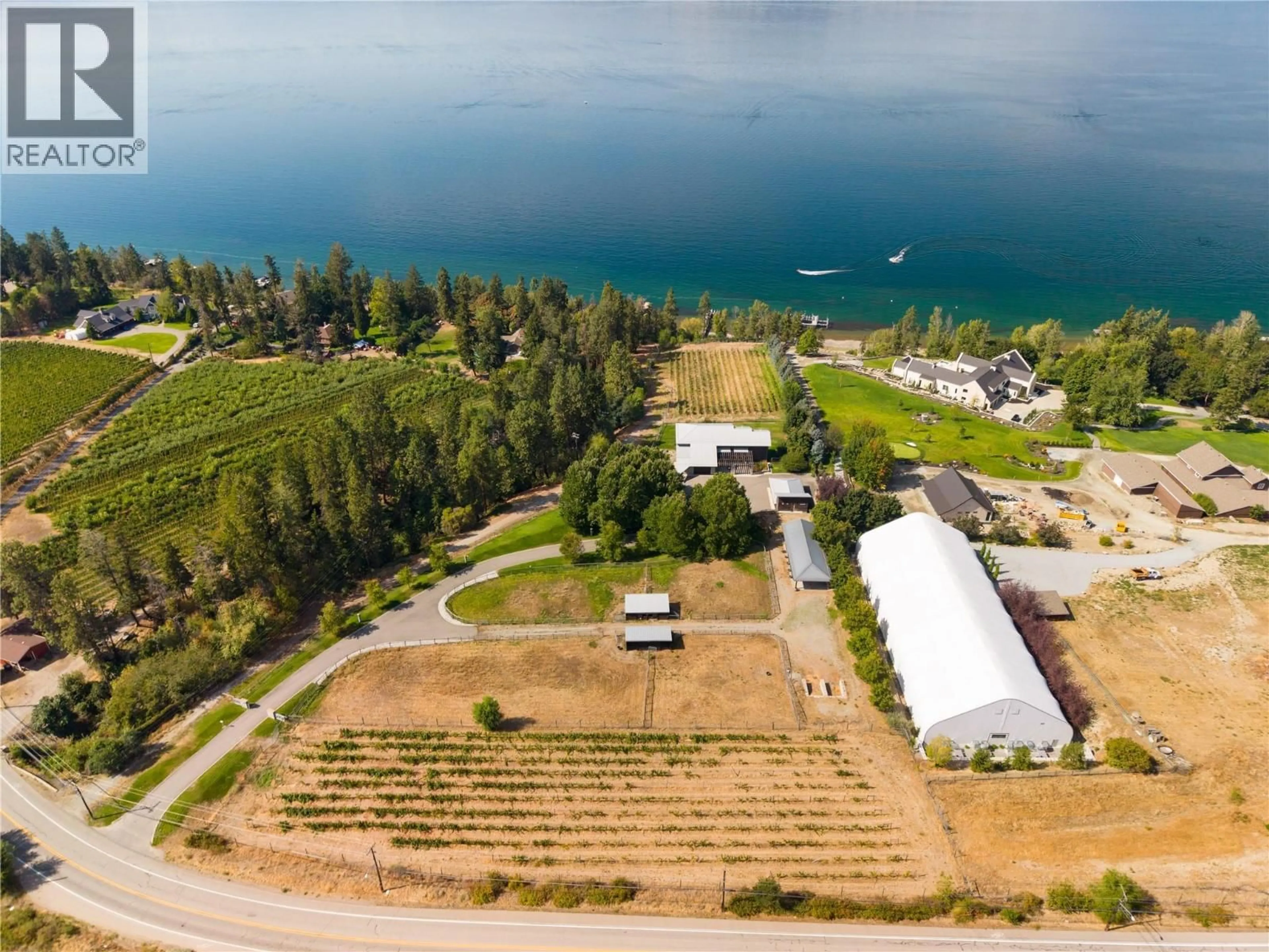 A pic from outside/outdoor area/front of a property/back of a property/a pic from drone, water/lake/river/ocean view for 4840 LAKESHORE ROAD, Kelowna British Columbia V1W4H6