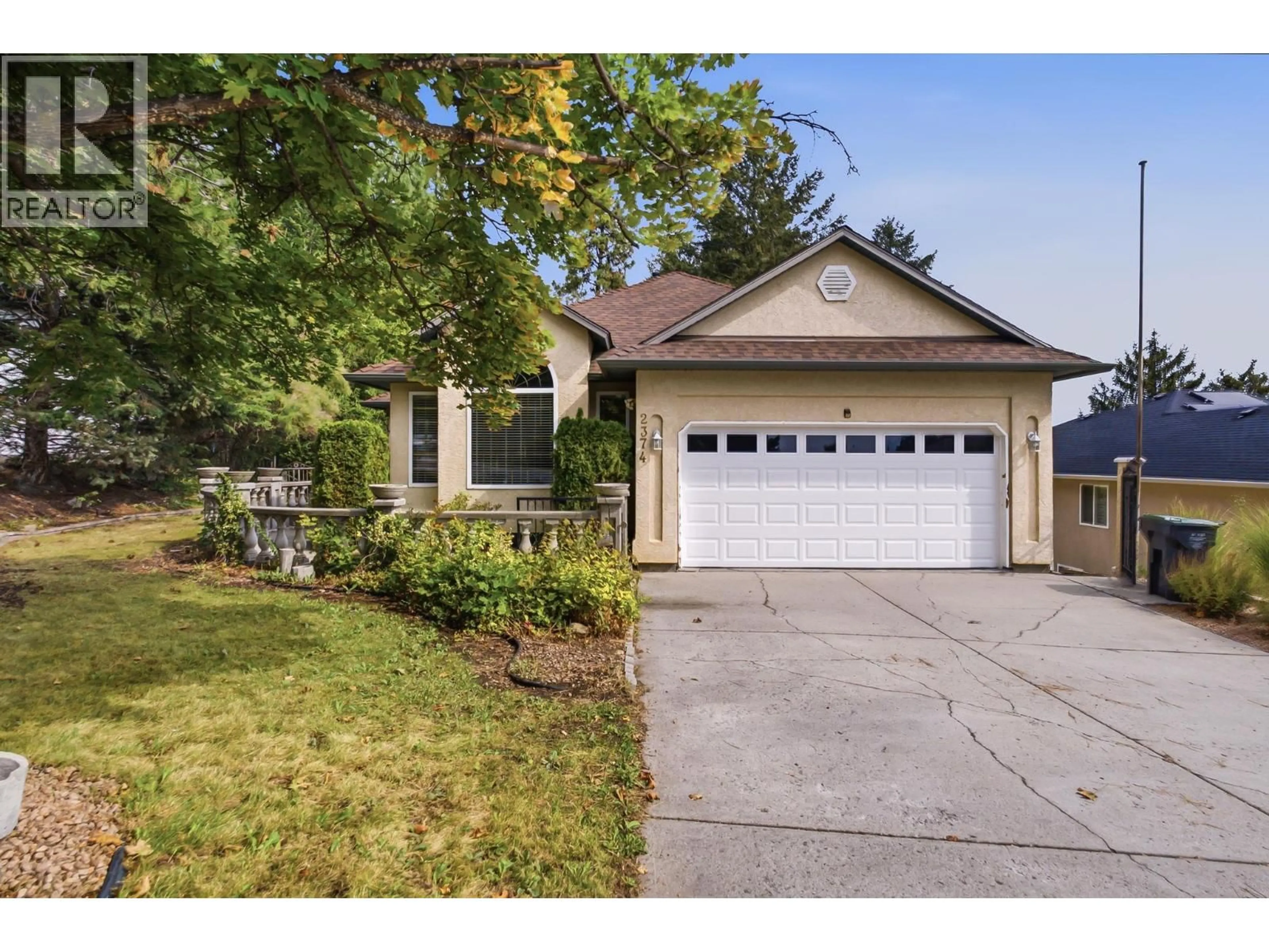 Home with vinyl exterior material, street for 2374 SHANNON WOODS DRIVE, West Kelowna British Columbia V4T2M1