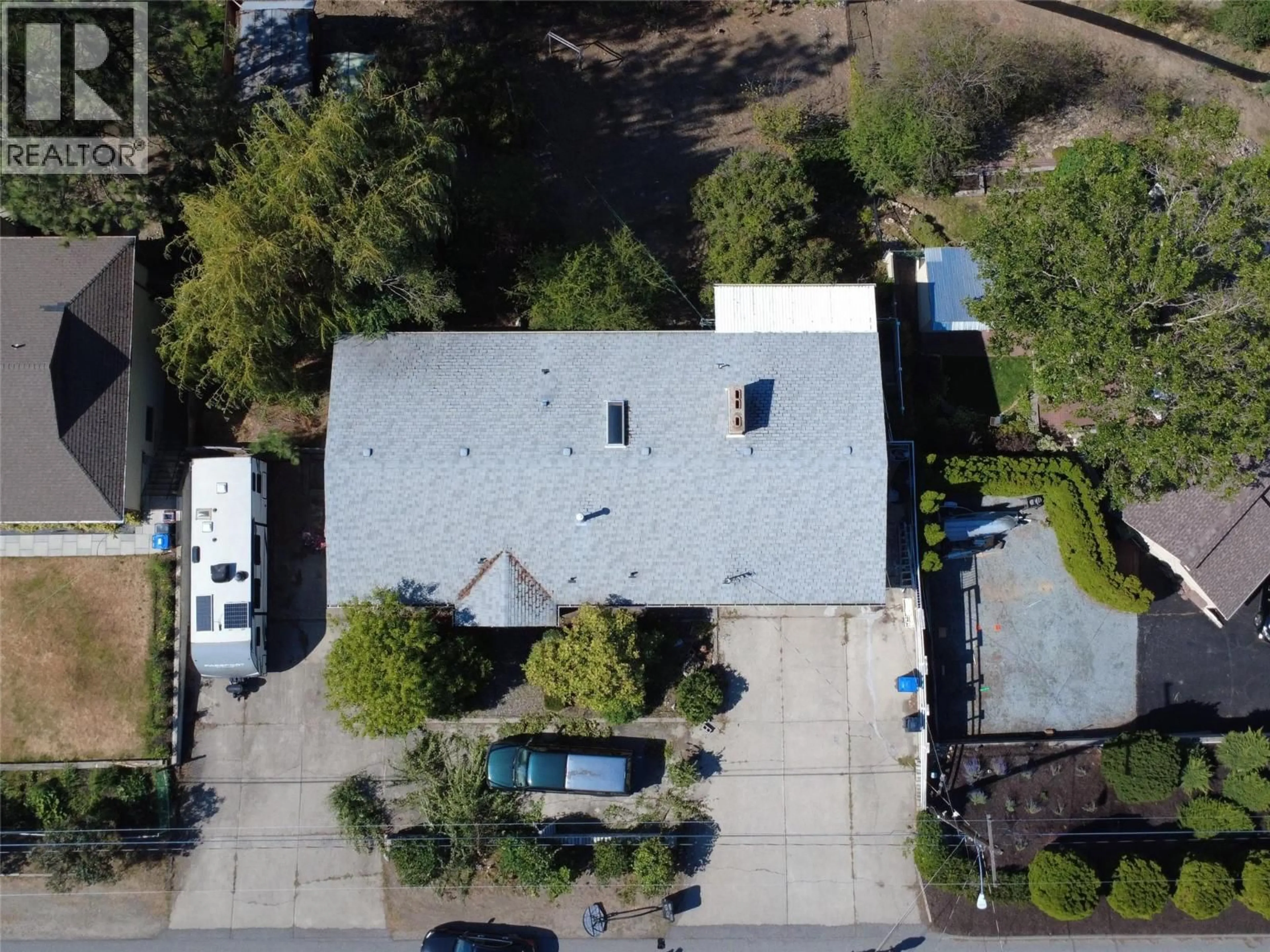 A pic from outside/outdoor area/front of a property/back of a property/a pic from drone, street for 1030 TOOVEY ROAD, Kelowna British Columbia V1X6R1