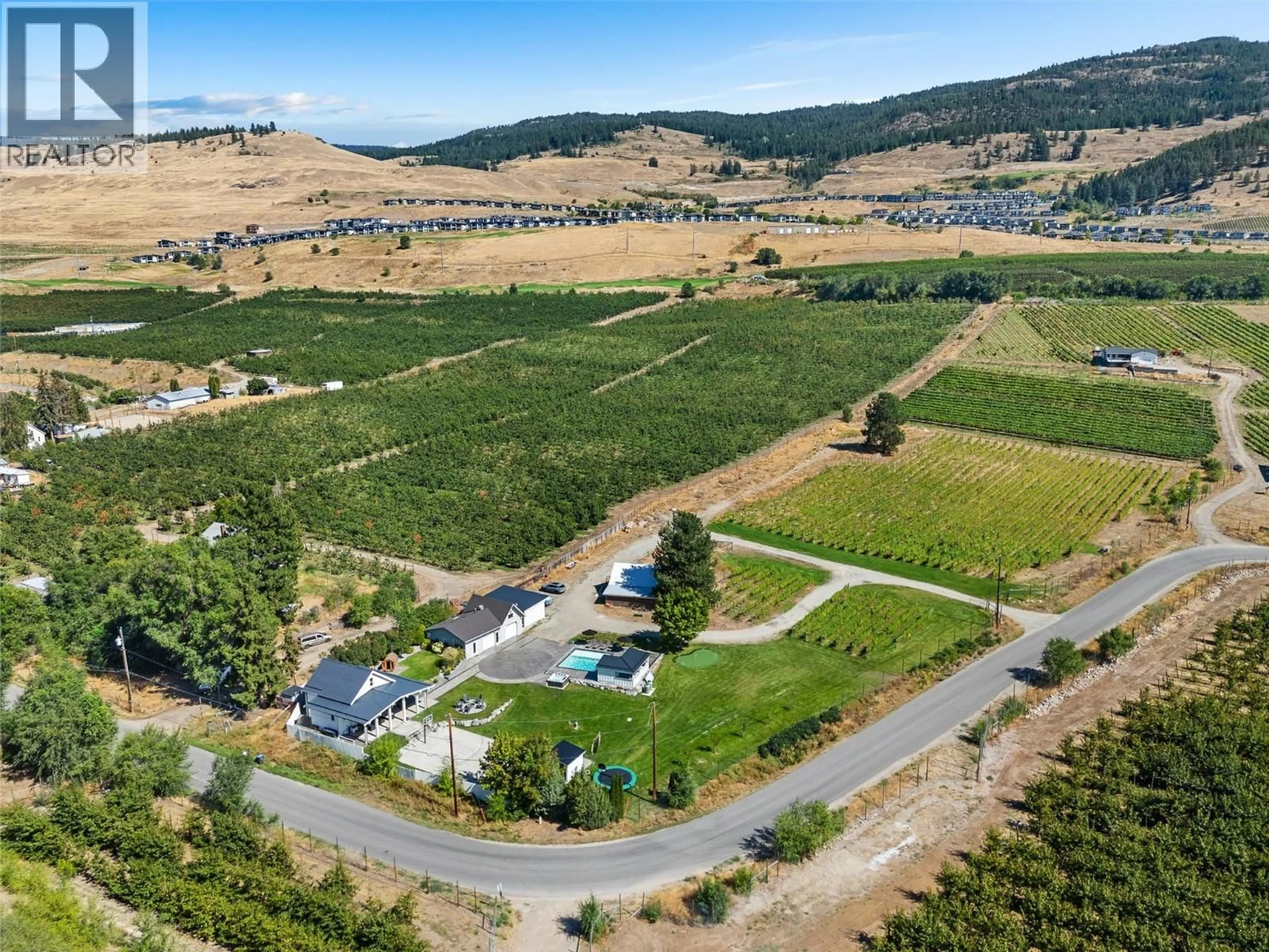A pic from outside/outdoor area/front of a property/back of a property/a pic from drone, mountain view for 1456 LATTA ROAD, Kelowna British Columbia V1P1B4