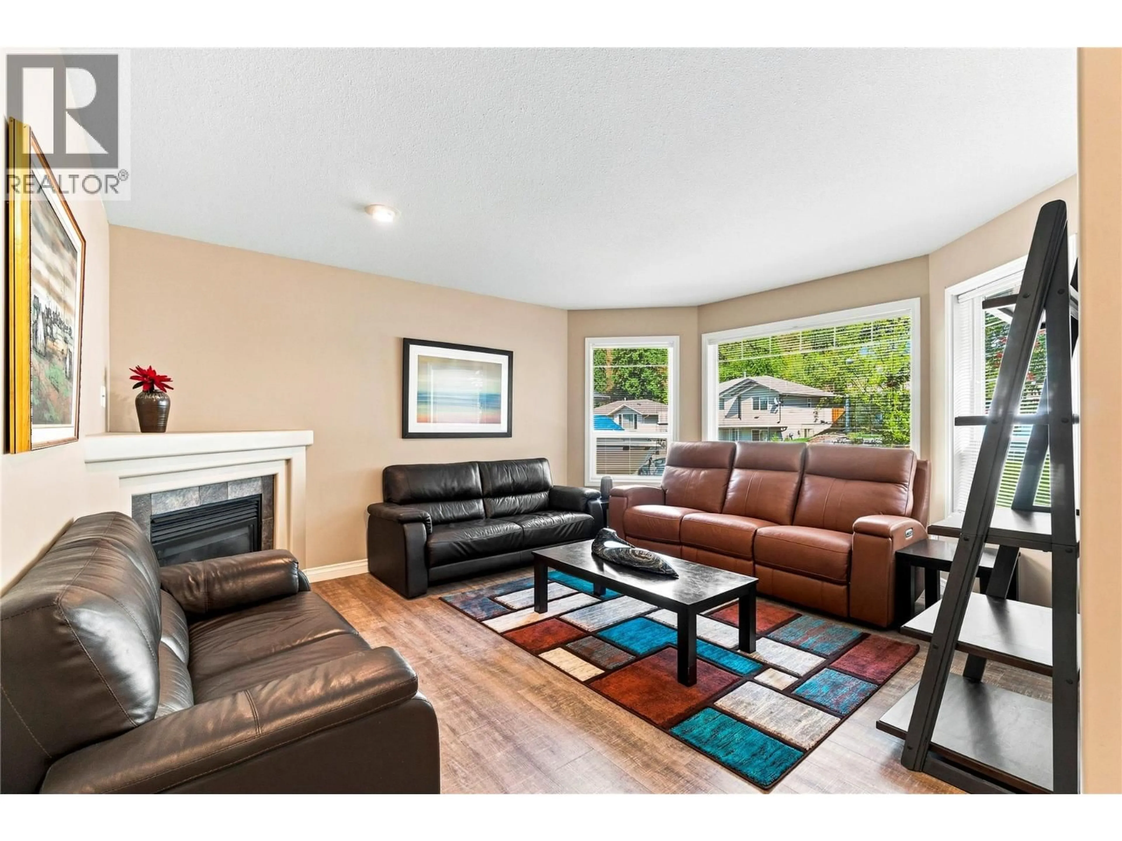 Living room with furniture, wood/laminate floor for 831 37 STREET SOUTHEAST, Salmon Arm British Columbia V1E3M2