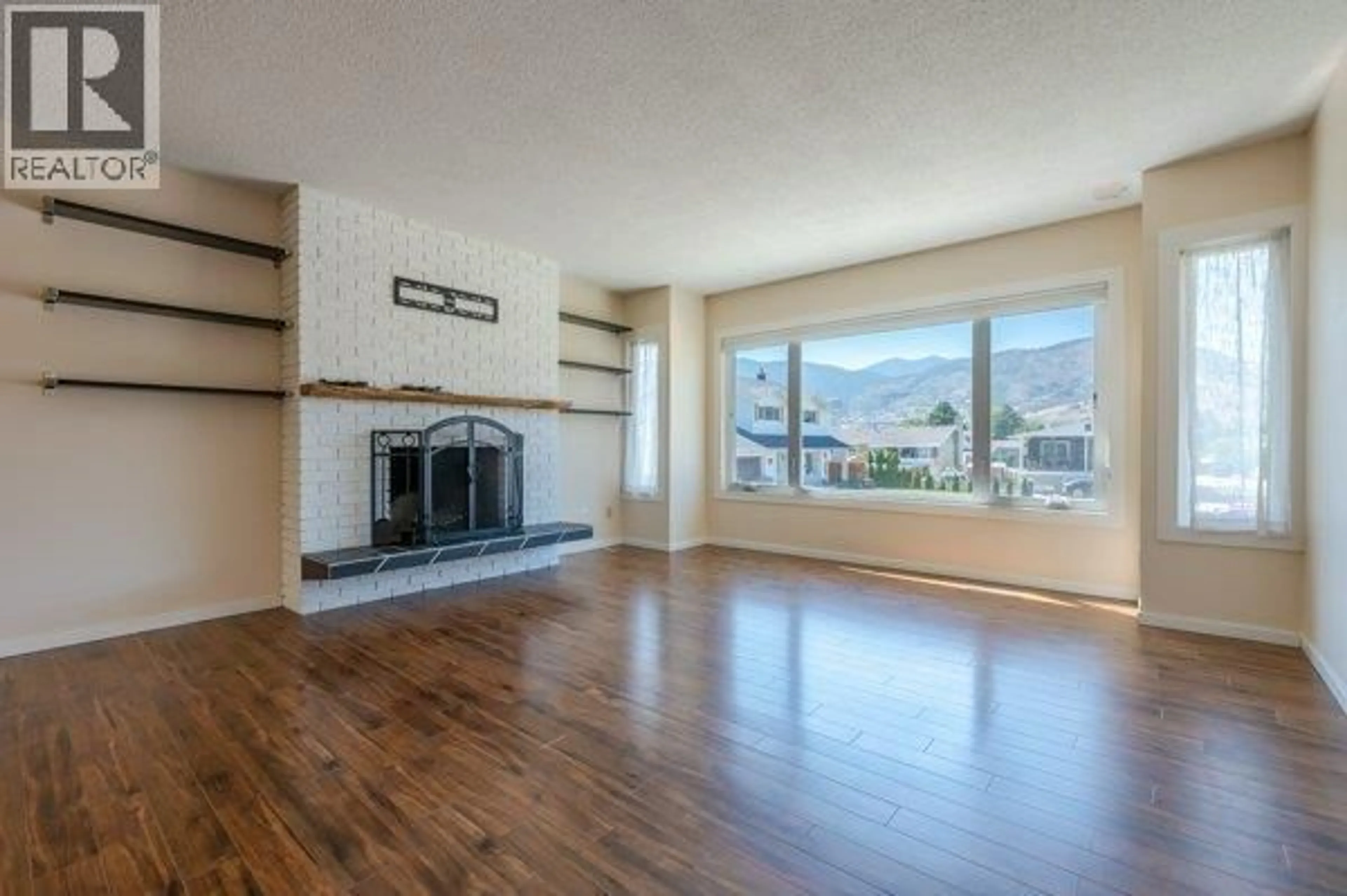 Living room with furniture, wood/laminate floor for 144 MCGRAW COURT, Penticton British Columbia V2A6Y6