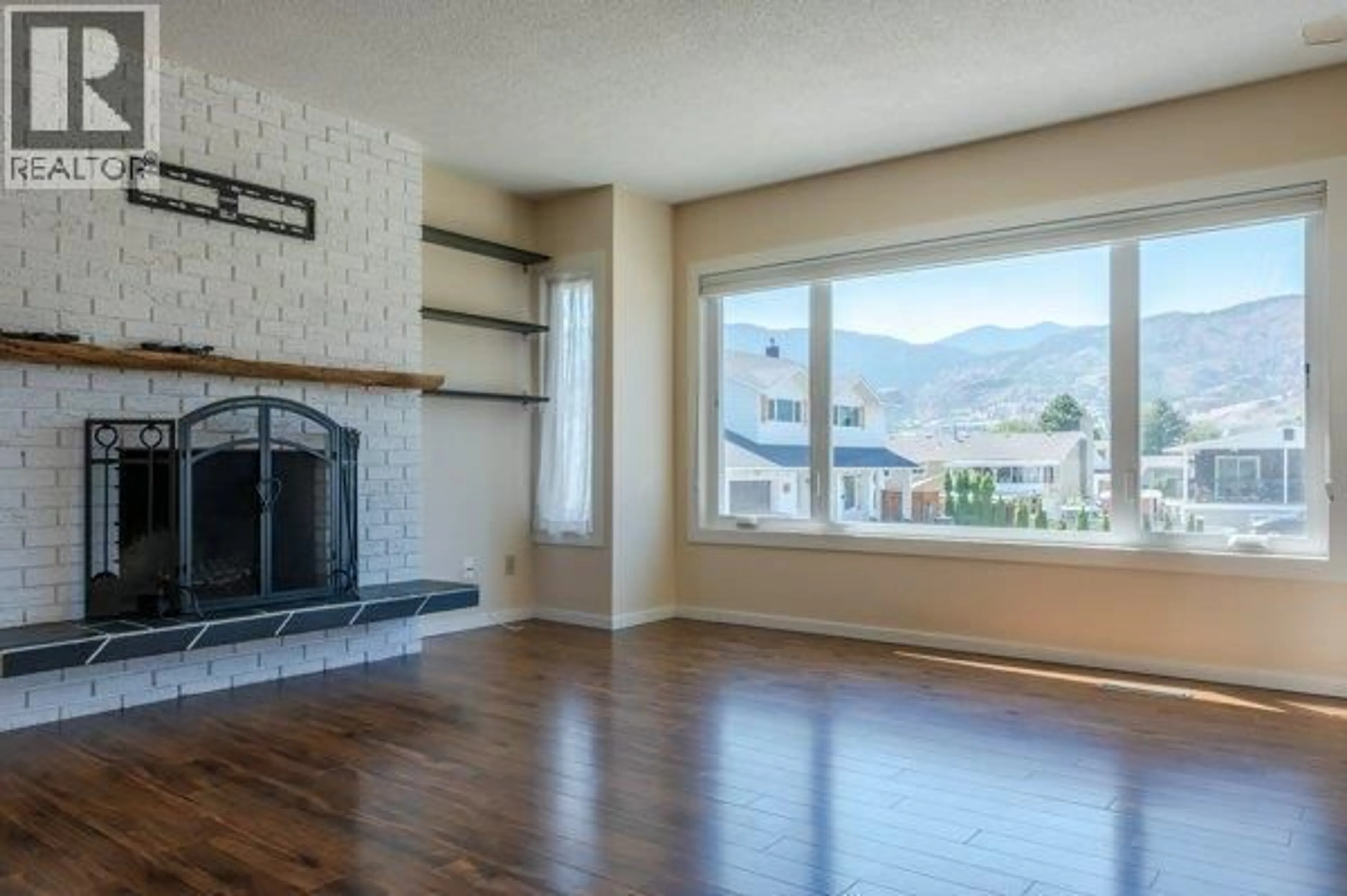 Living room with furniture, wood/laminate floor for 144 MCGRAW COURT, Penticton British Columbia V2A6Y6