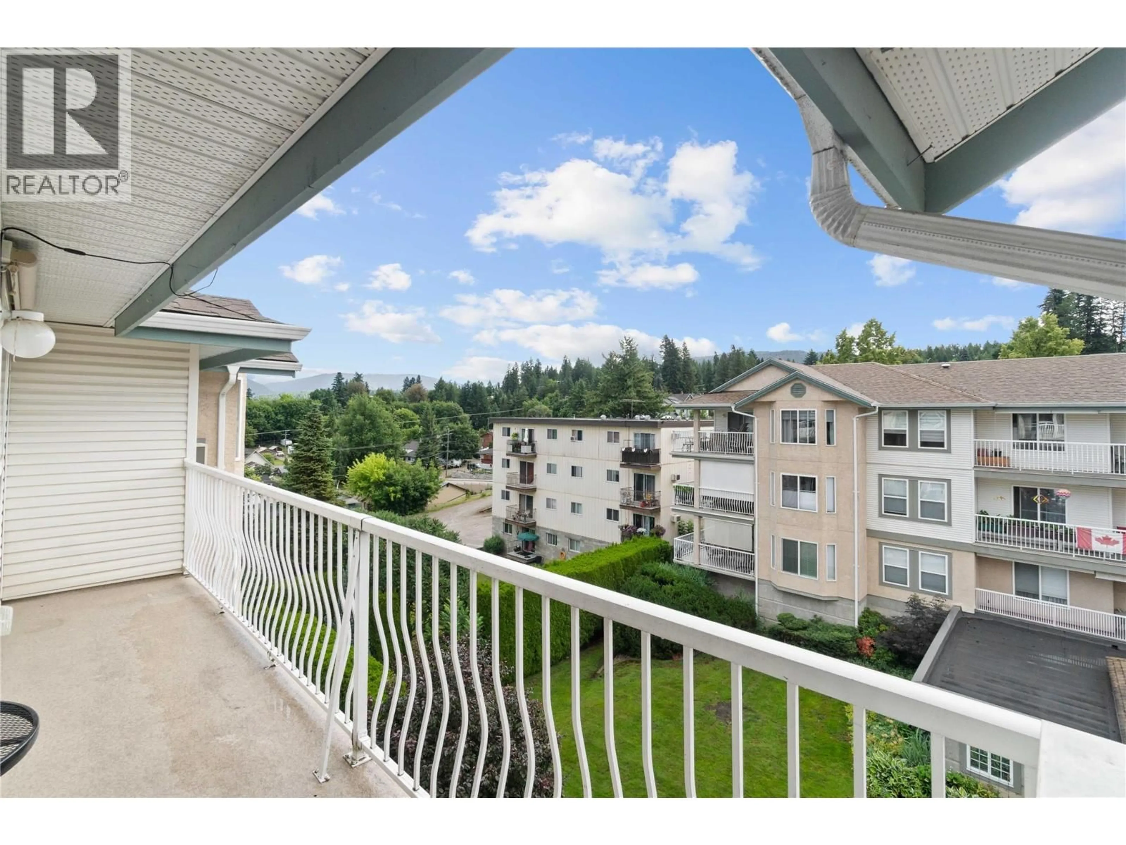 Patio, city buildings view from balcony for 313 - 250 5 STREET SOUTHEAST, Salmon Arm British Columbia V1E1J8
