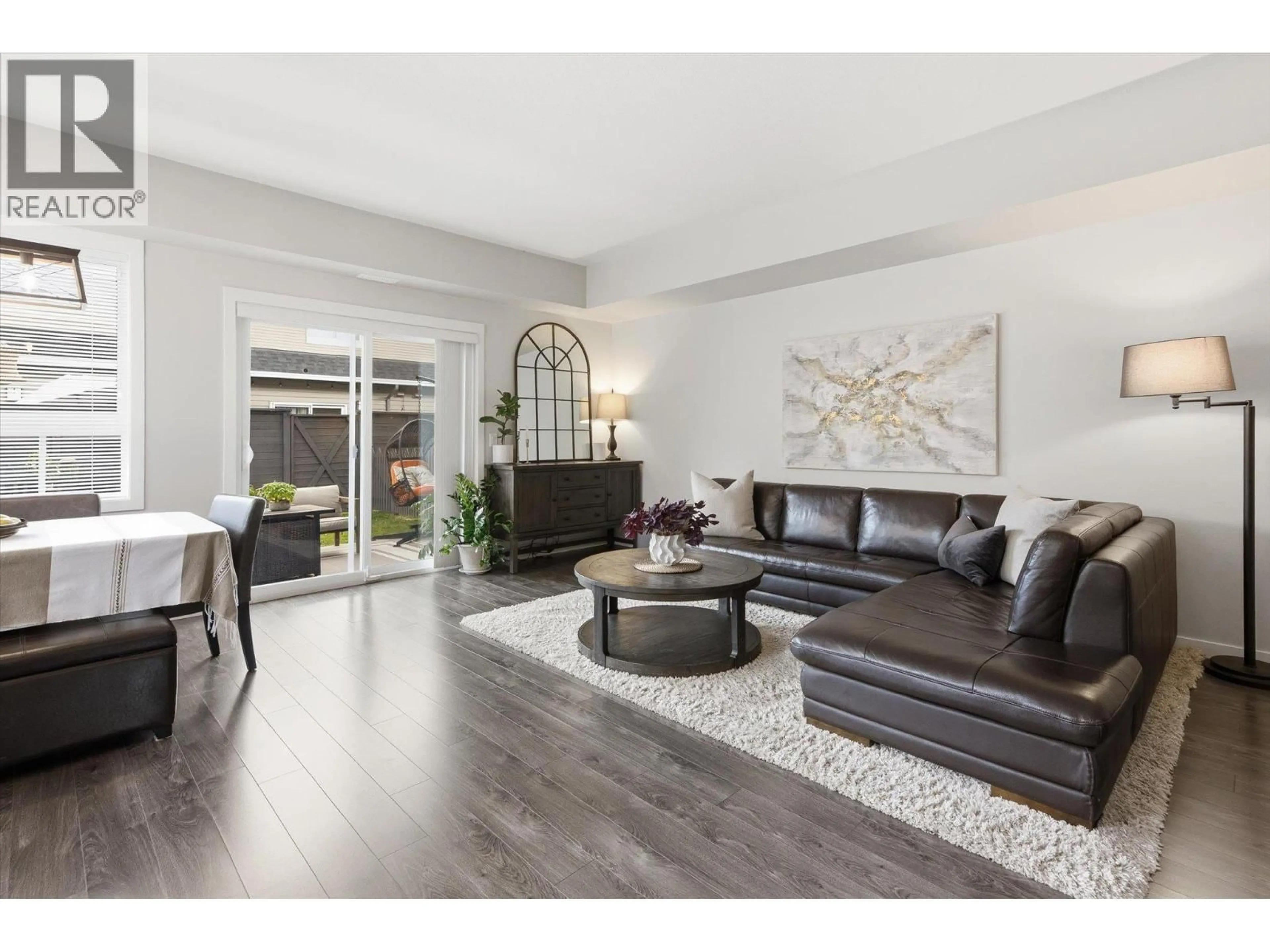 Living room with furniture, wood/laminate floor for 18 - 680 OLD MEADOWS ROAD, Kelowna British Columbia V1W5L4