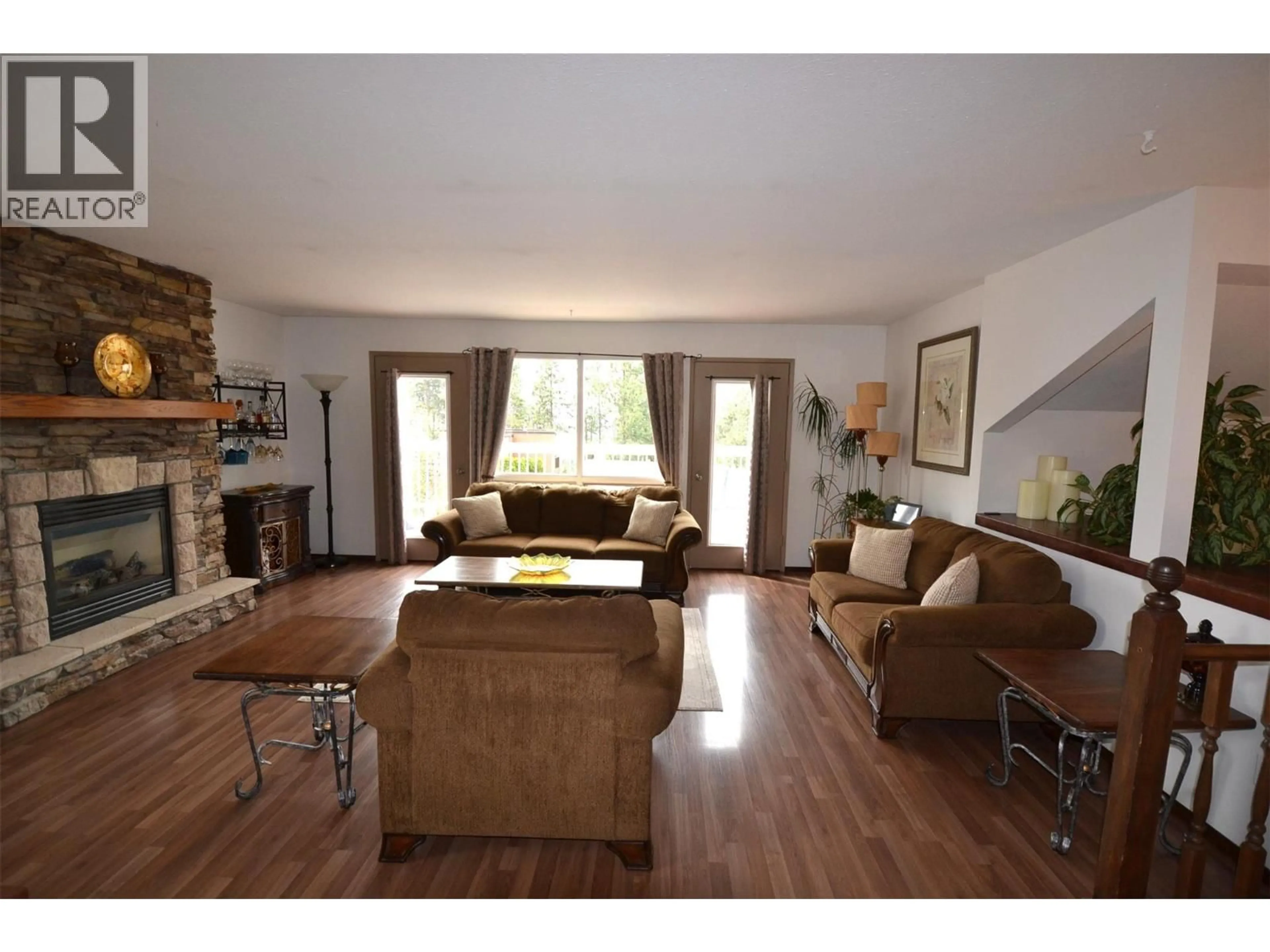 Living room with furniture, wood/laminate floor for 3944 TREPANIER HEIGHTS AVENUE, Peachland British Columbia V0H1X2