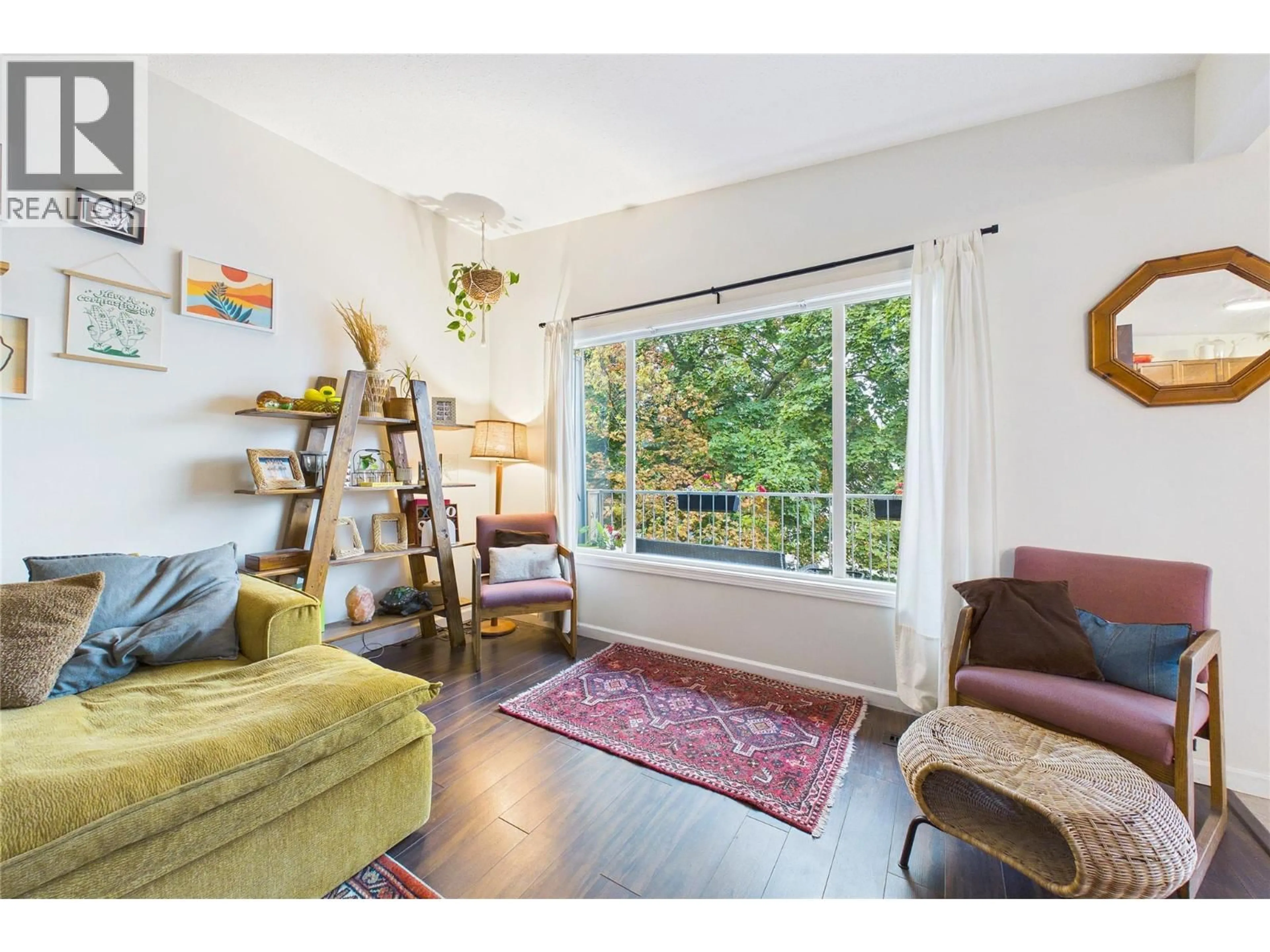 Living room with furniture, wood/laminate floor for 1393 HIGHLAND DRIVE SOUTH, Kelowna British Columbia V1Y3W2