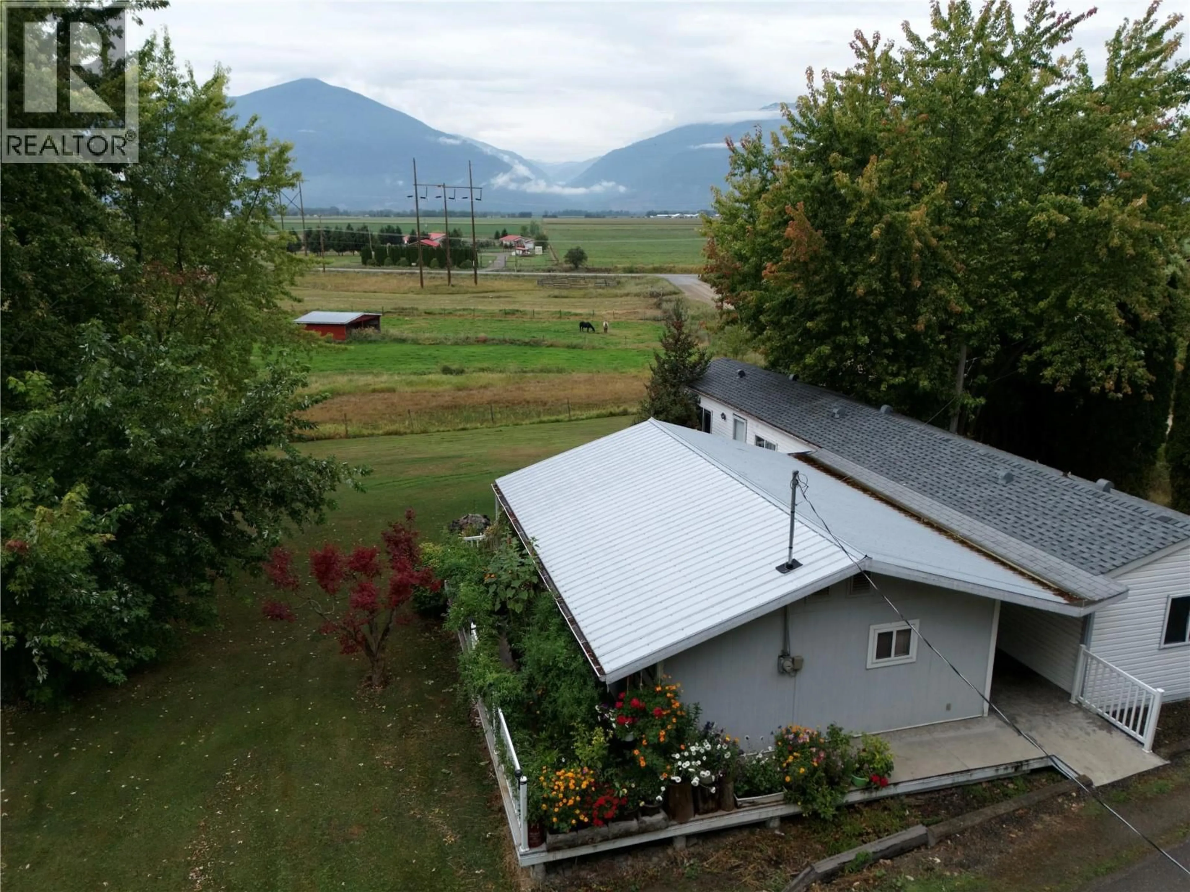 A pic from outside/outdoor area/front of a property/back of a property/a pic from drone, mountain view for 1-2780 ROCKY POINT ROAD, Creston British Columbia V0B1G8