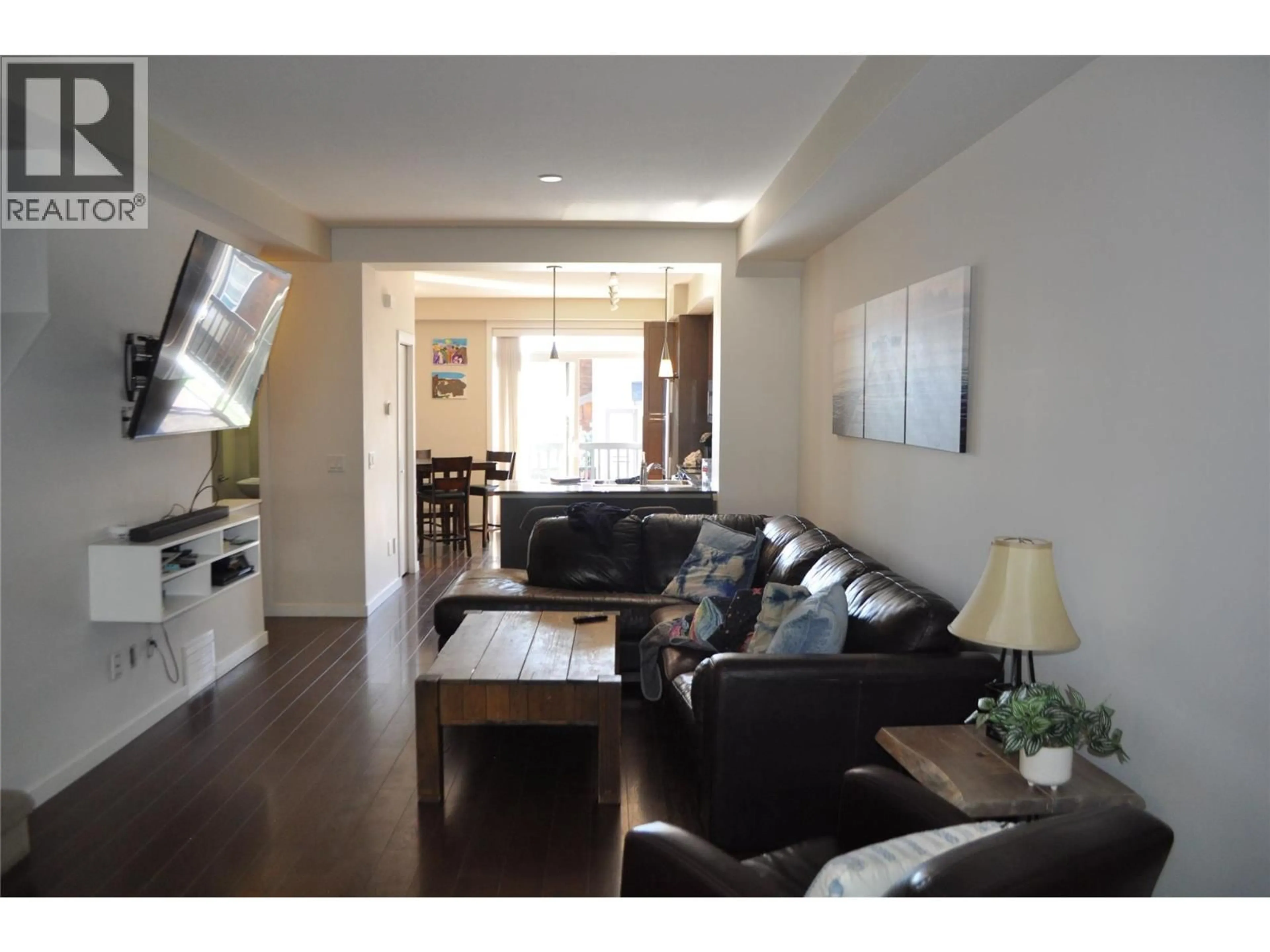 Living room with furniture, wood/laminate floor for 601 BOYNTON PLACE, Kelowna British Columbia V1V3B5
