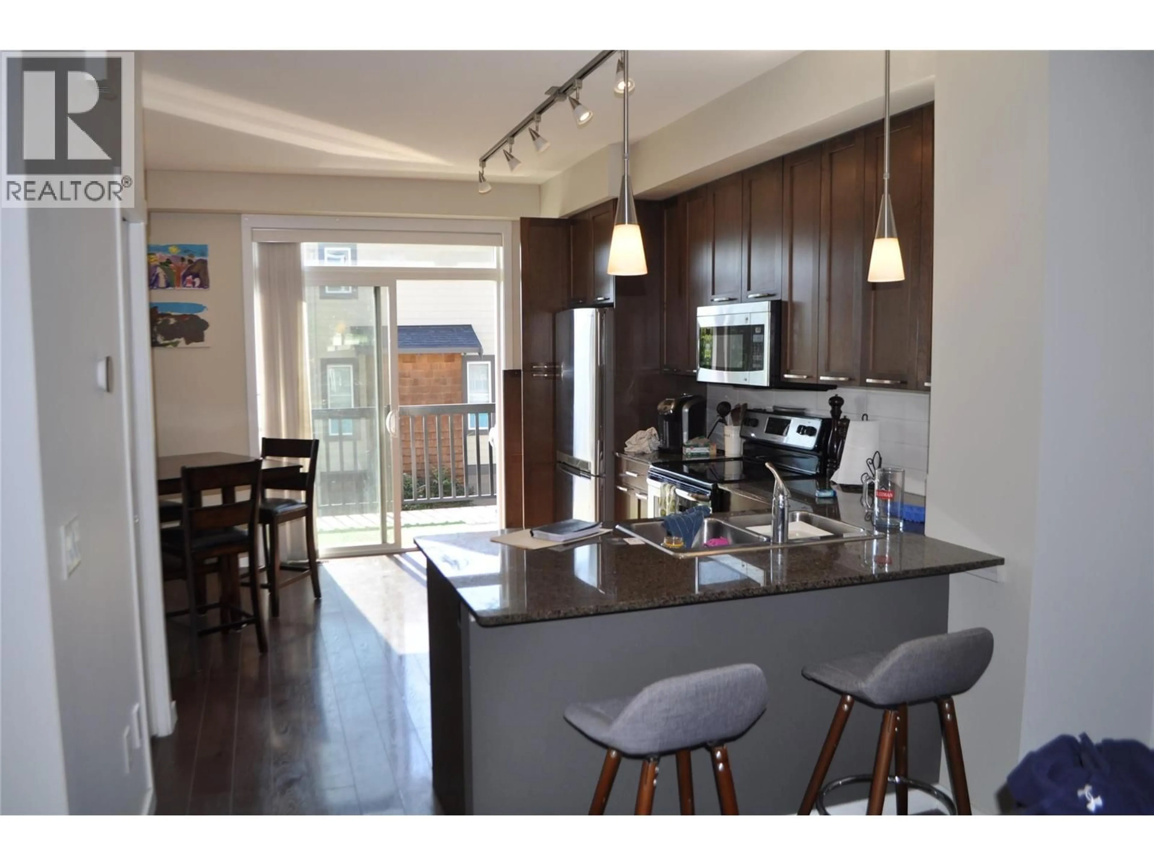 Open concept kitchen, wood/laminate floor for 601 BOYNTON PLACE, Kelowna British Columbia V1V3B5