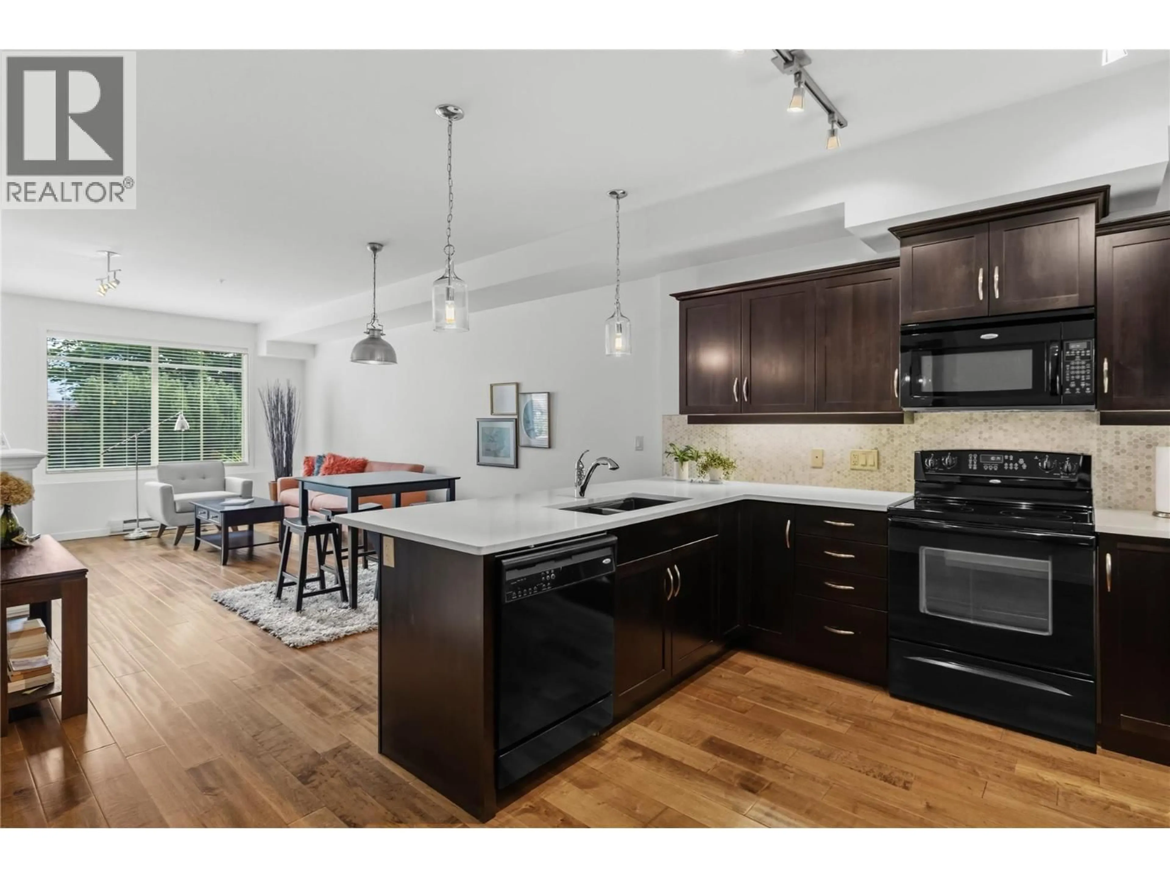Open concept kitchen, wood/laminate floor for 110 - 3735 CASORSO ROAD, Kelowna British Columbia V1W5G1
