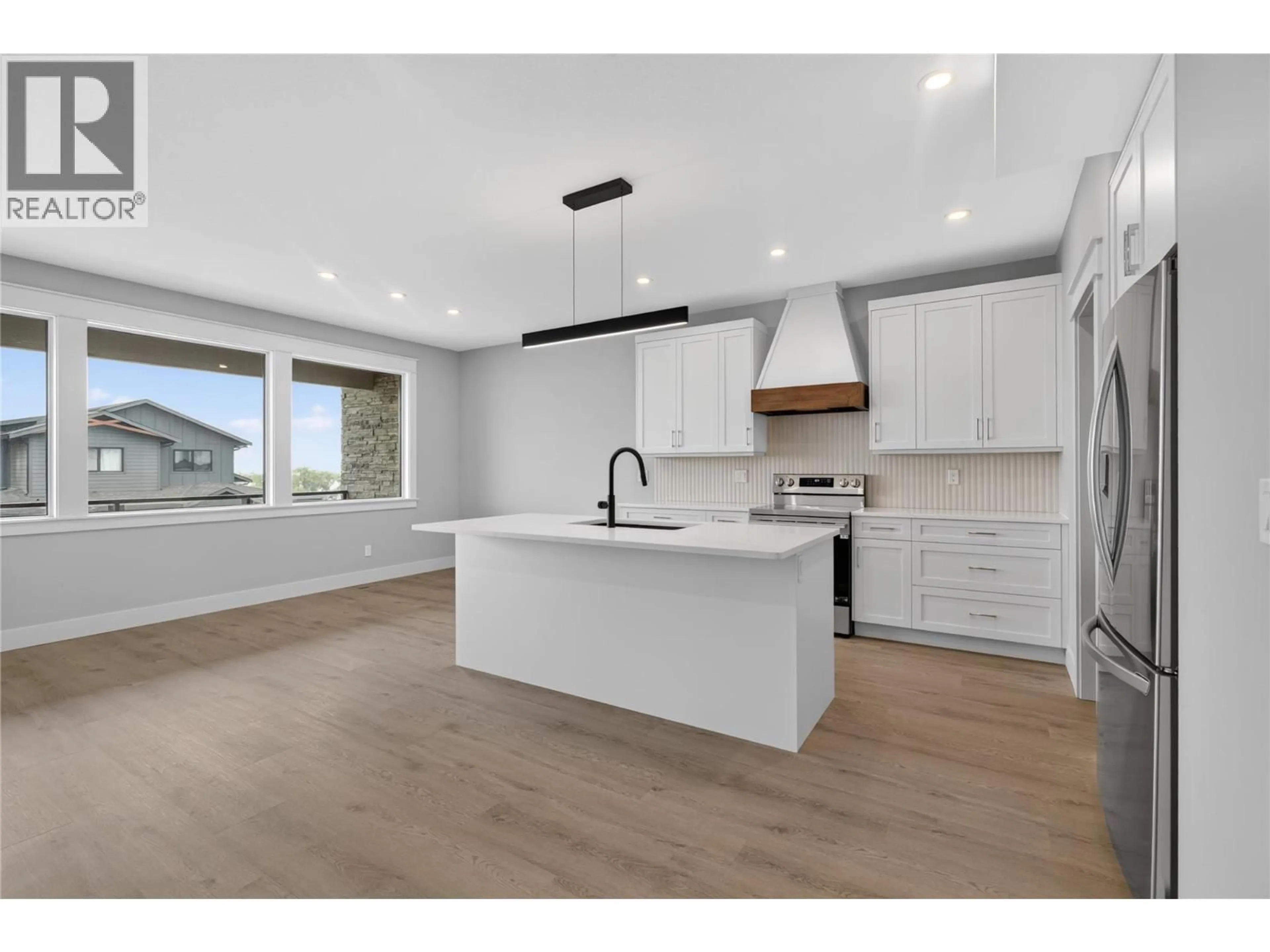 Open concept kitchen, wood/laminate floor for 4315 PAINTED TURTLE DRIVE, Vernon British Columbia V1H1A2