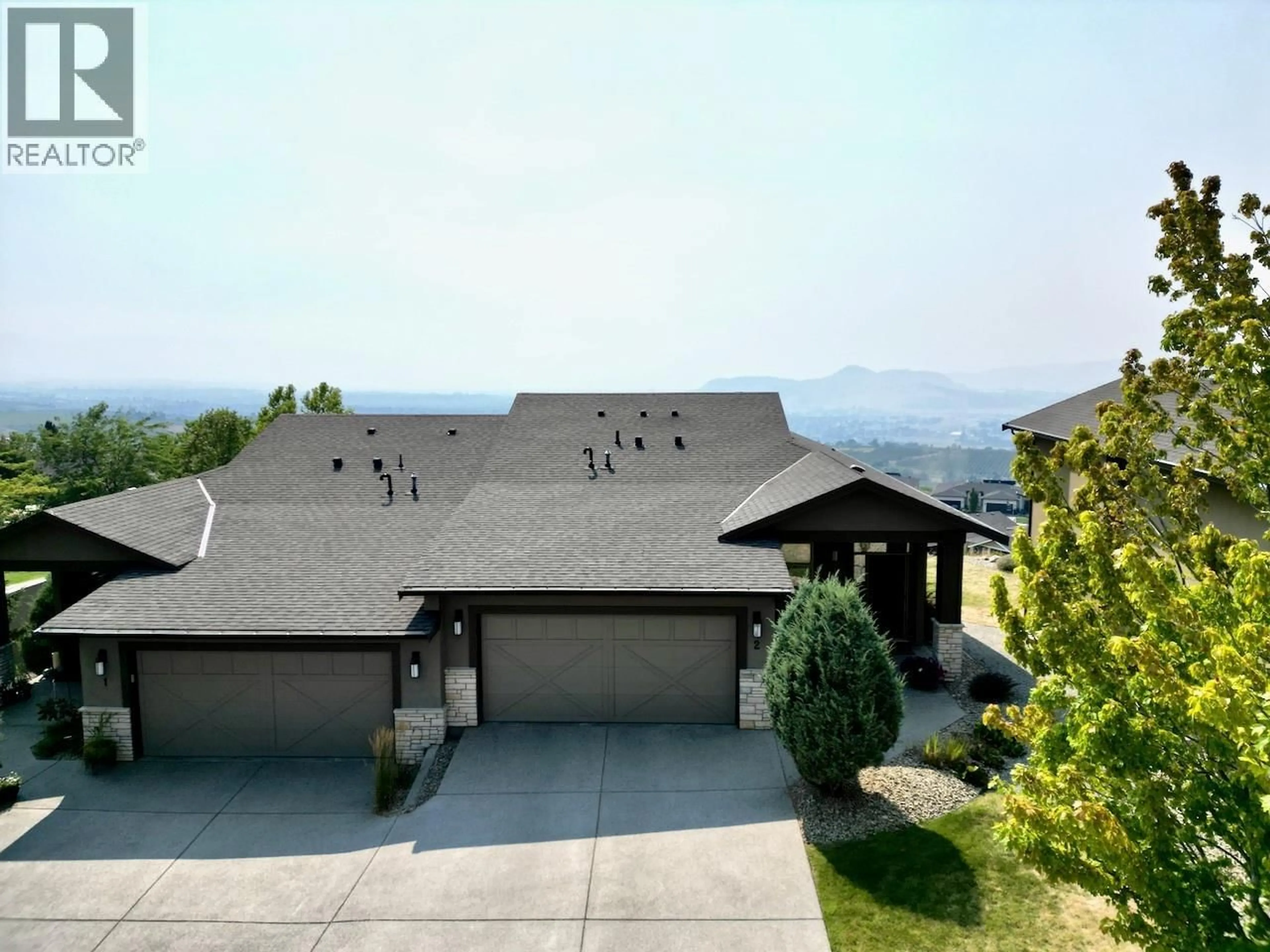 A pic from outside/outdoor area/front of a property/back of a property/a pic from drone, mountain view for 2 - 1836 TOWER RANCH BOULEVARD, Kelowna British Columbia V1P1S8