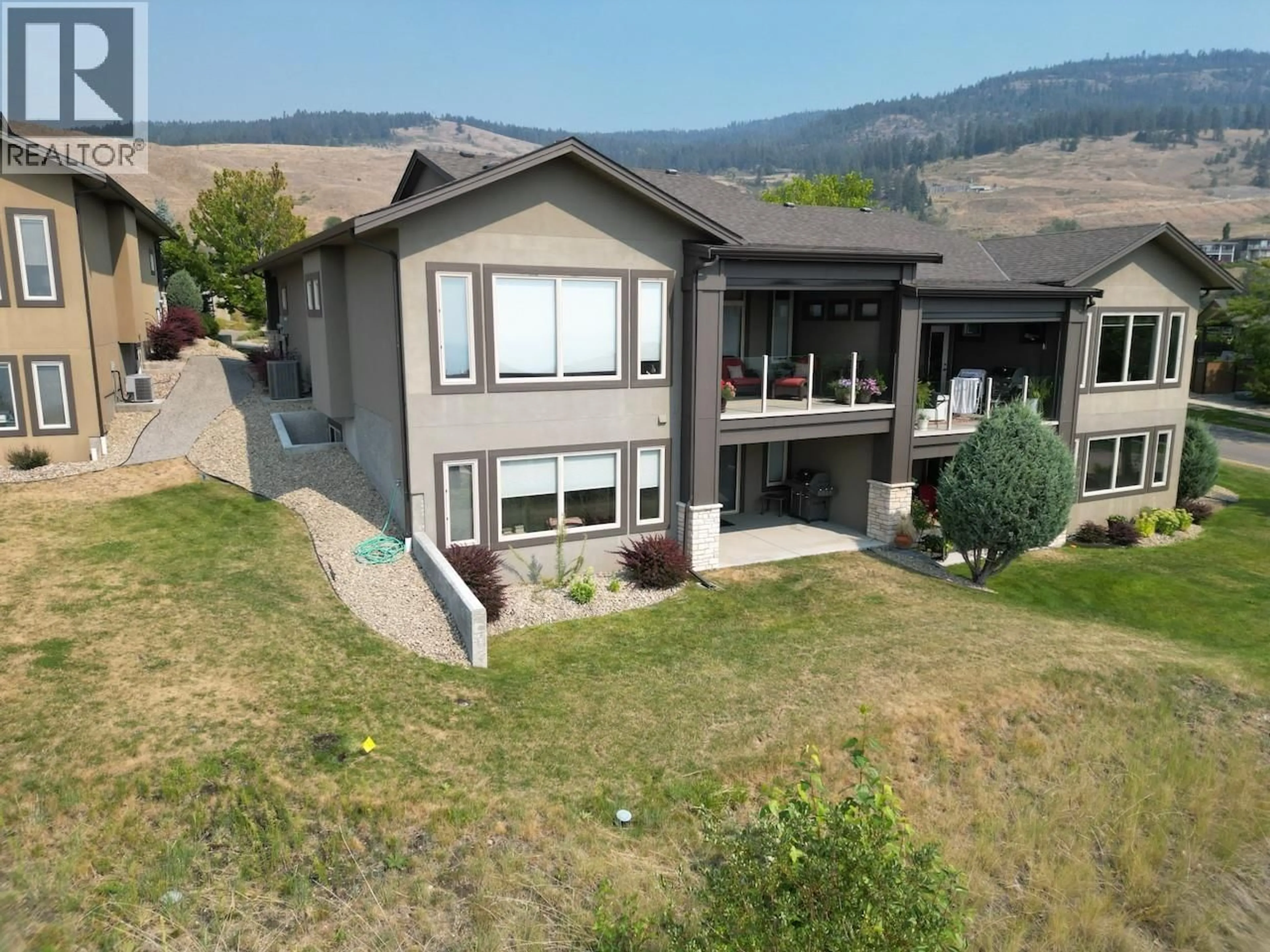 A pic from outside/outdoor area/front of a property/back of a property/a pic from drone, mountain view for 2 - 1836 TOWER RANCH BOULEVARD, Kelowna British Columbia V1P1S8