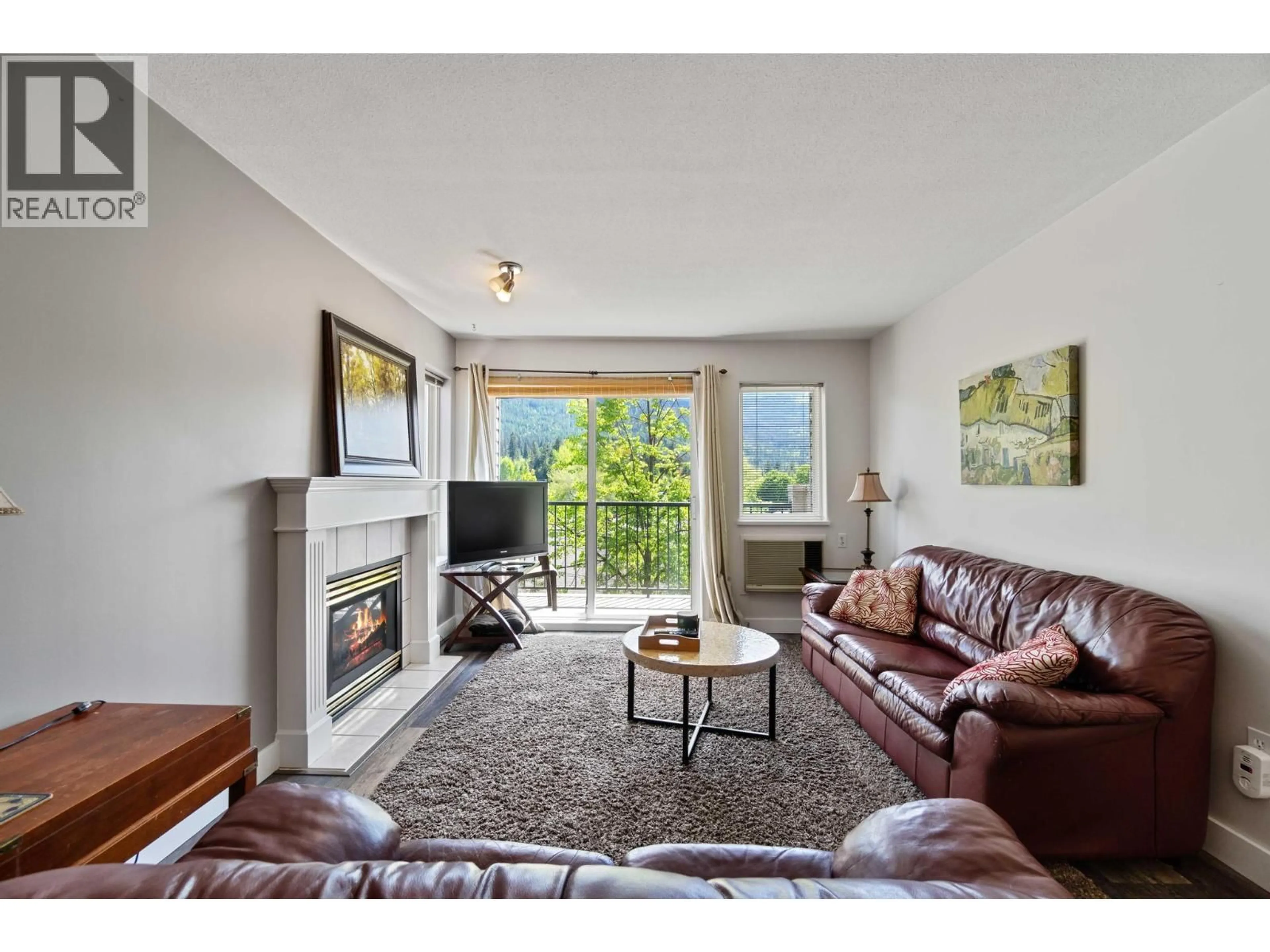 Living room with furniture, wood/laminate floor for 207 - 650 3 STREET, Salmon Arm British Columbia v1e2z7
