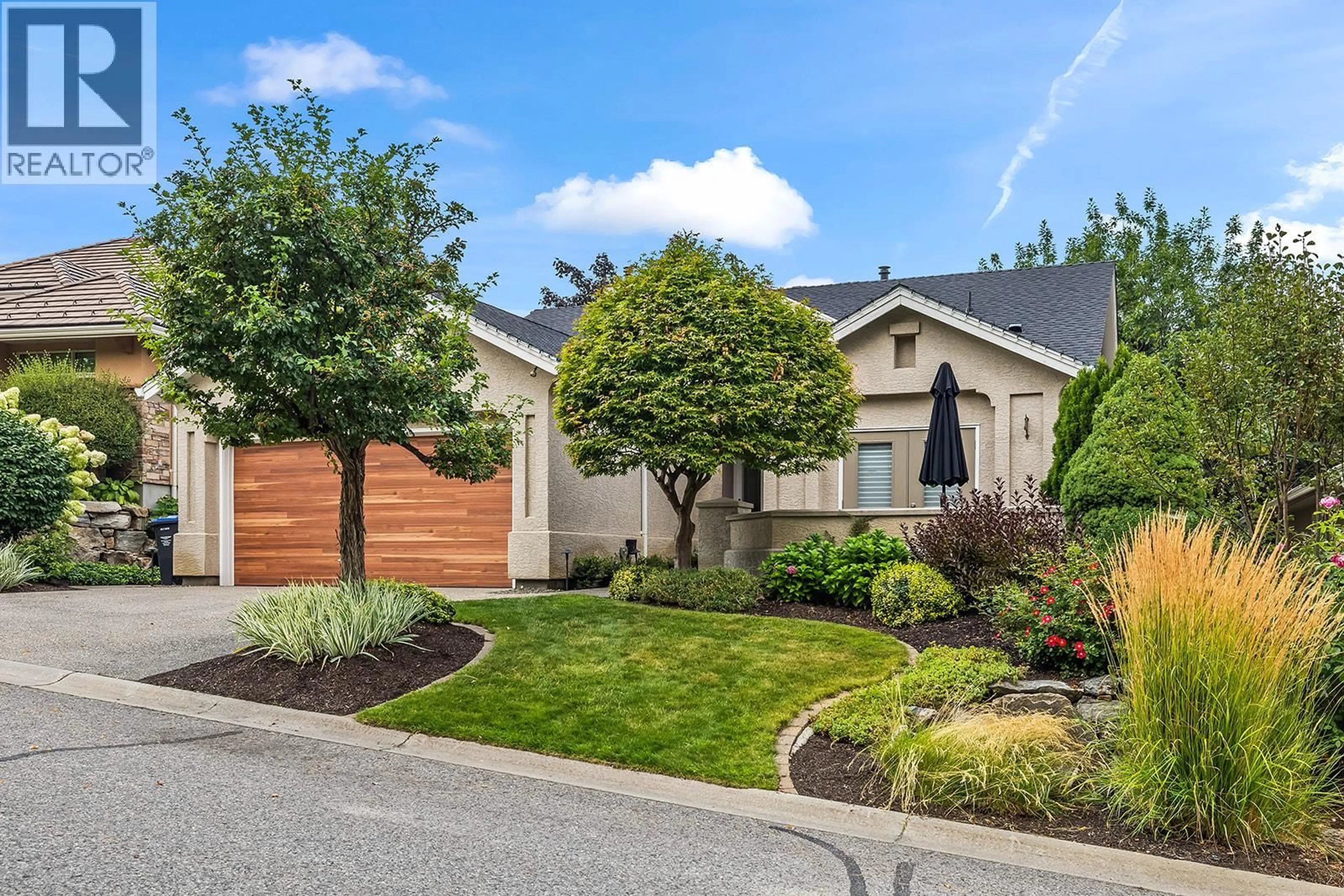 Home with vinyl exterior material, street for 4125 GALLAGHERS PARKLAND DRIVE, Kelowna British Columbia V1W3Z8