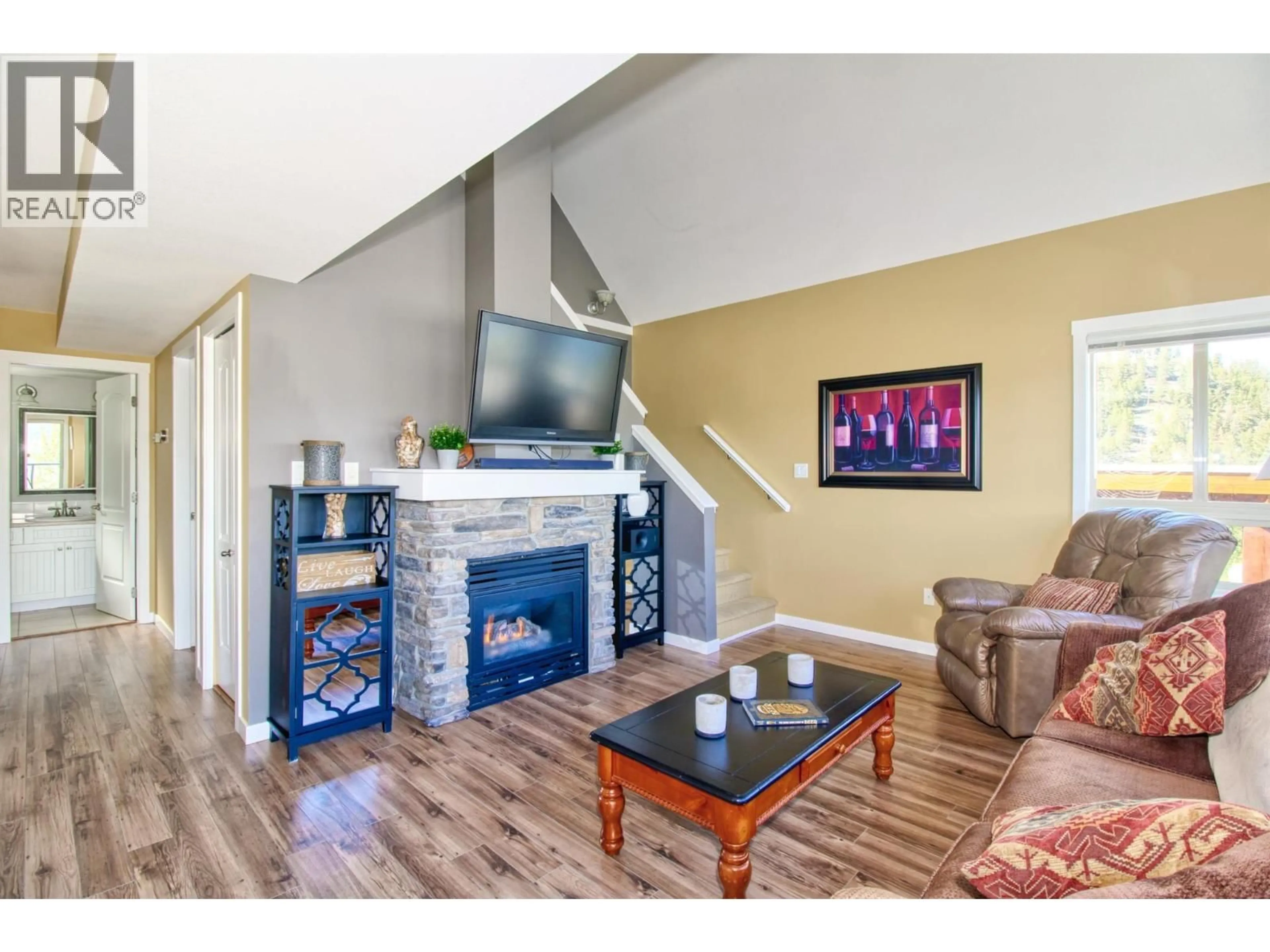 Living room with furniture, wood/laminate floor for 115 - 6871 SANTIAGO LOOP, Kelowna British Columbia V1Z3R8