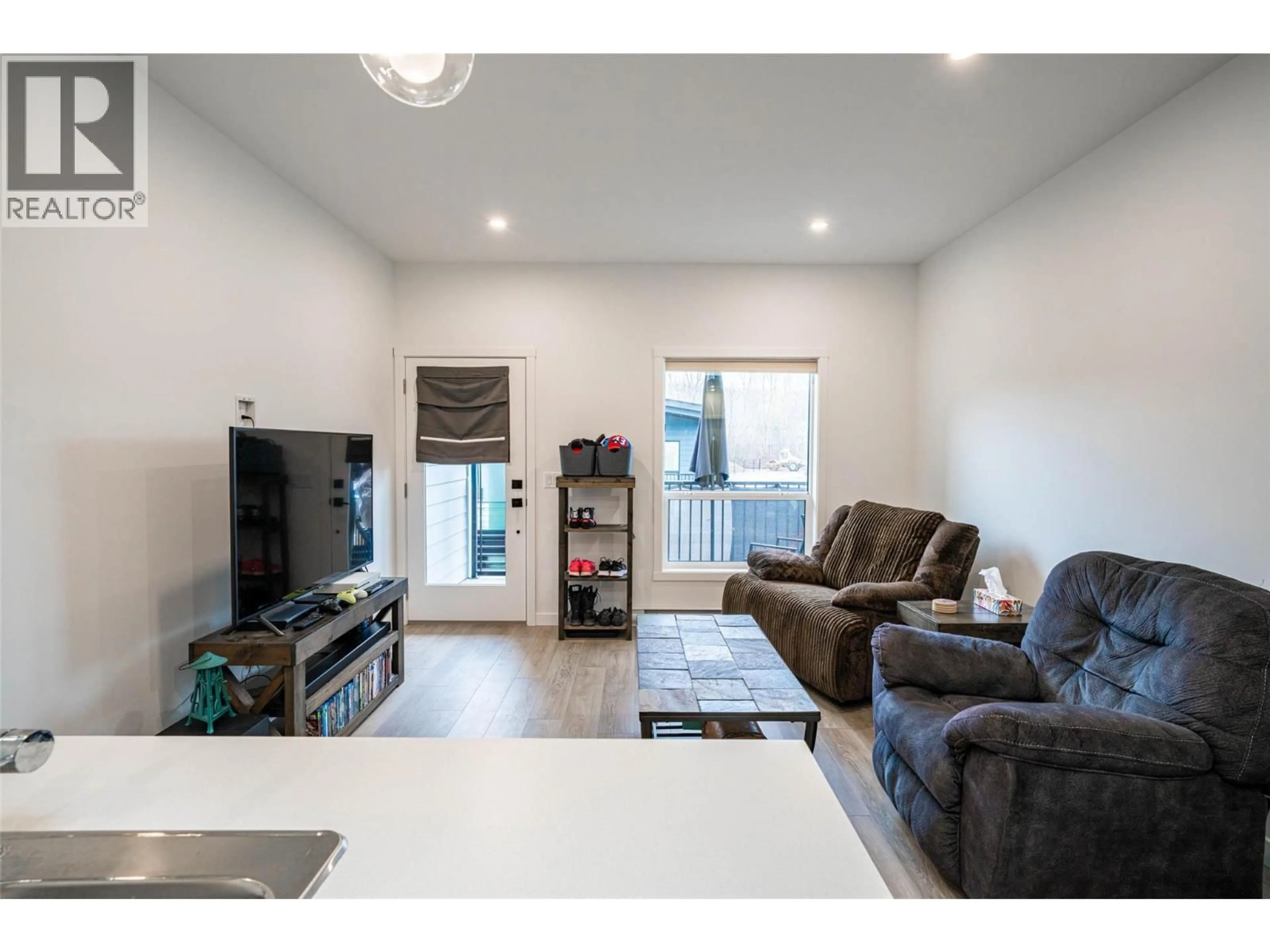 Living room with furniture, wood/laminate floor for 206E - 8900 JIM BAILEY ROAD, Kelowna British Columbia V4V1E8