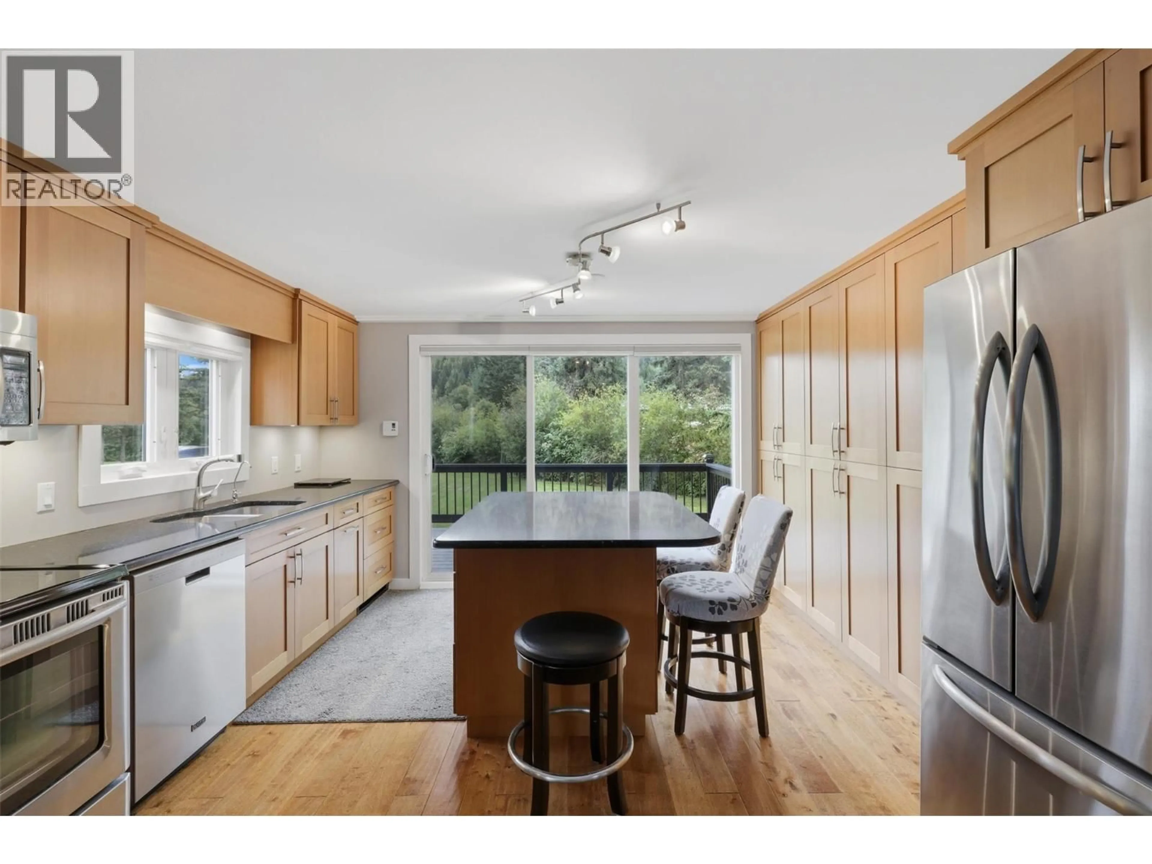 Open concept kitchen, wood/laminate floor for 3016 MCCREIGHT ROAD, Kamloops British Columbia V0E3E1