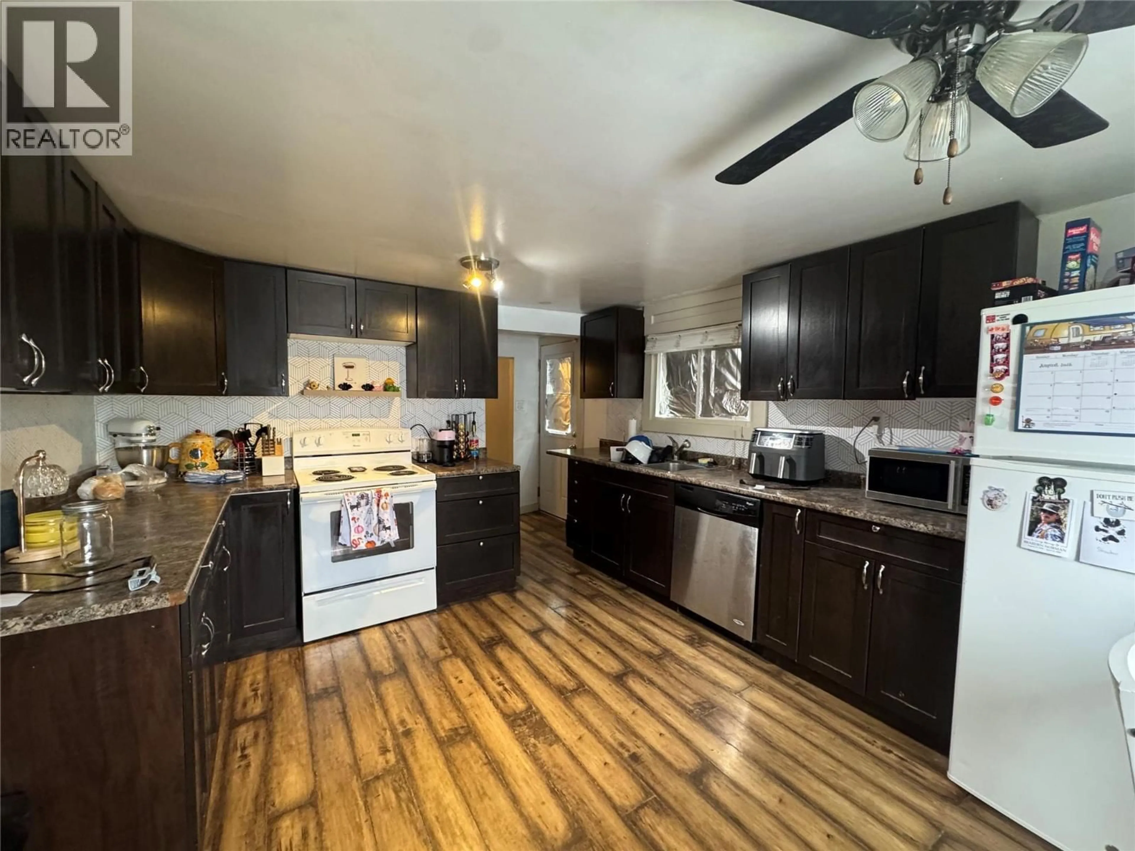 Open concept kitchen, wood/laminate floor for 872 107 AVENUE, Dawson Creek British Columbia V1G2R2