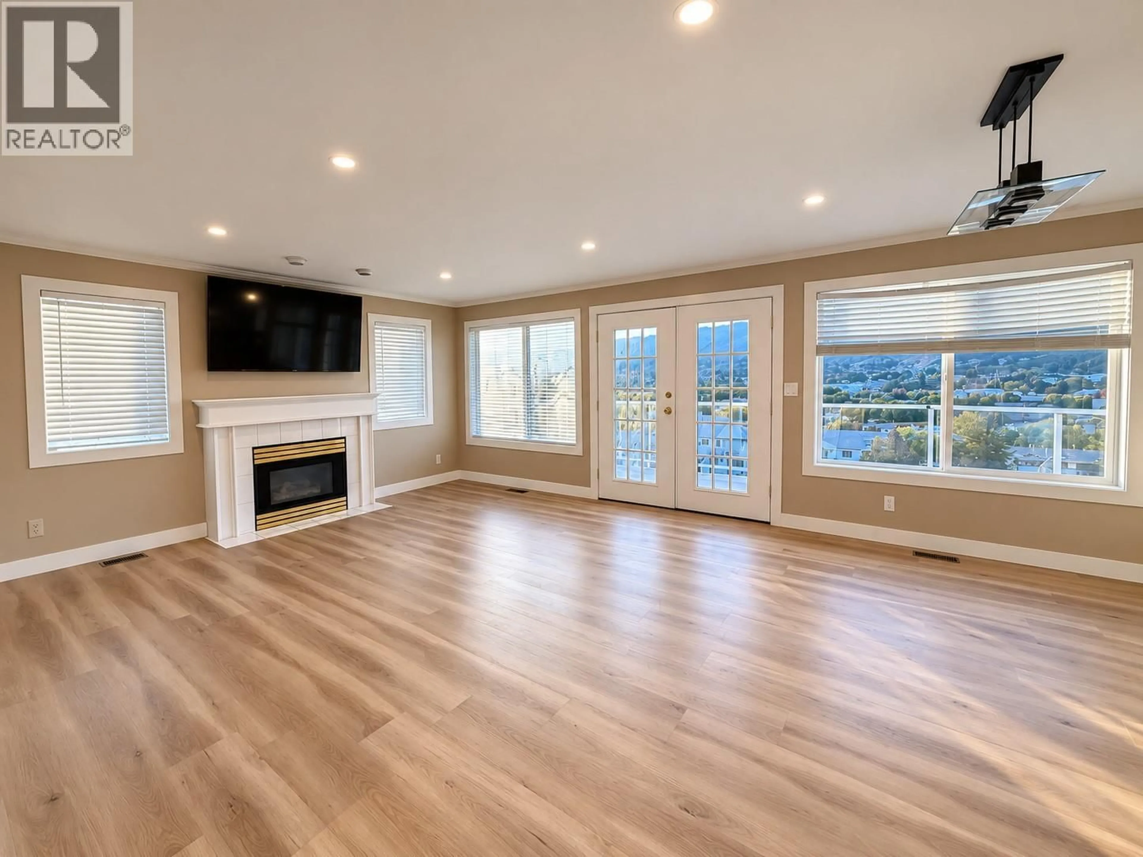 Living room with furniture, wood/laminate floor for 4305 WESTVIEW DRIVE, Vernon British Columbia V1T9B2