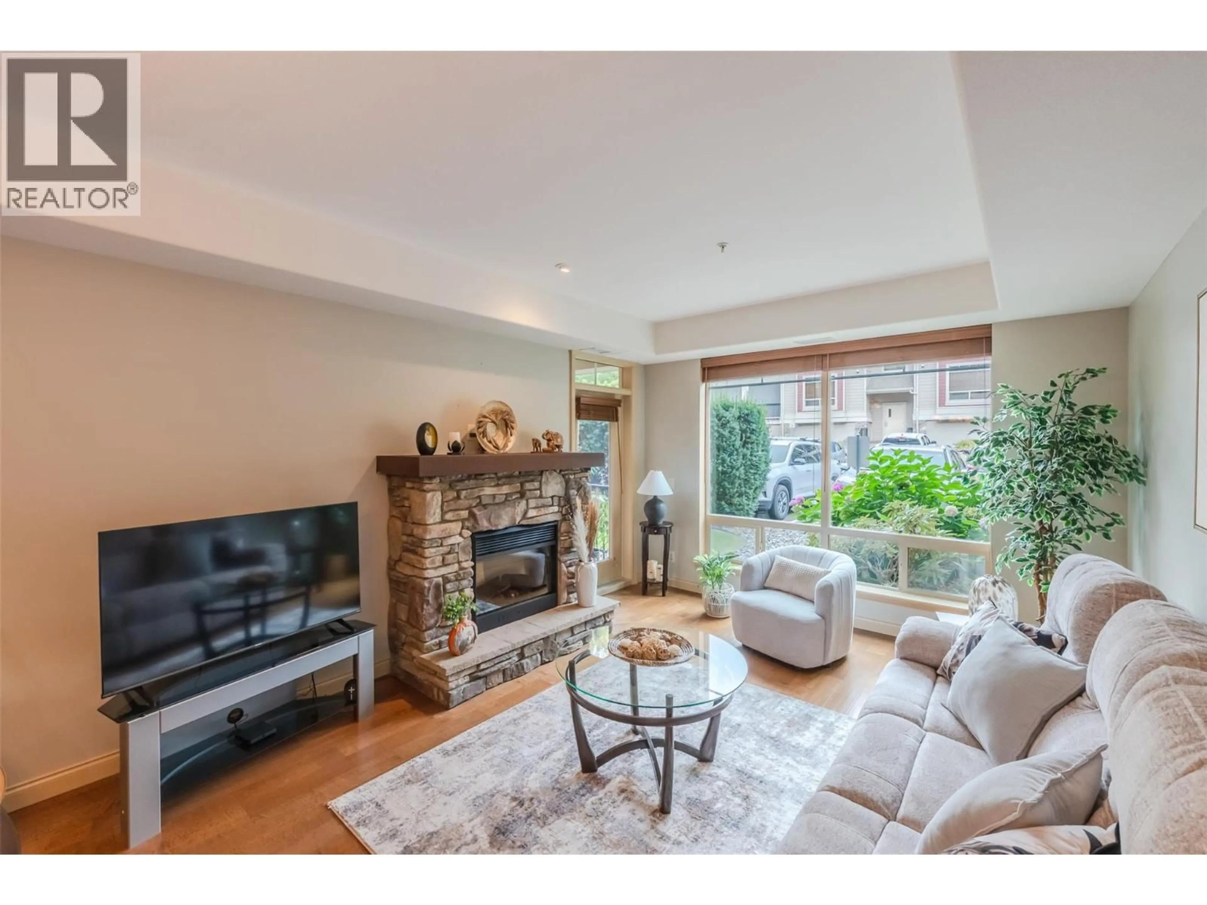 Living room with furniture, wood/laminate floor for 112 - 2750 AUBURN ROAD, West Kelowna British Columbia V4T4C2