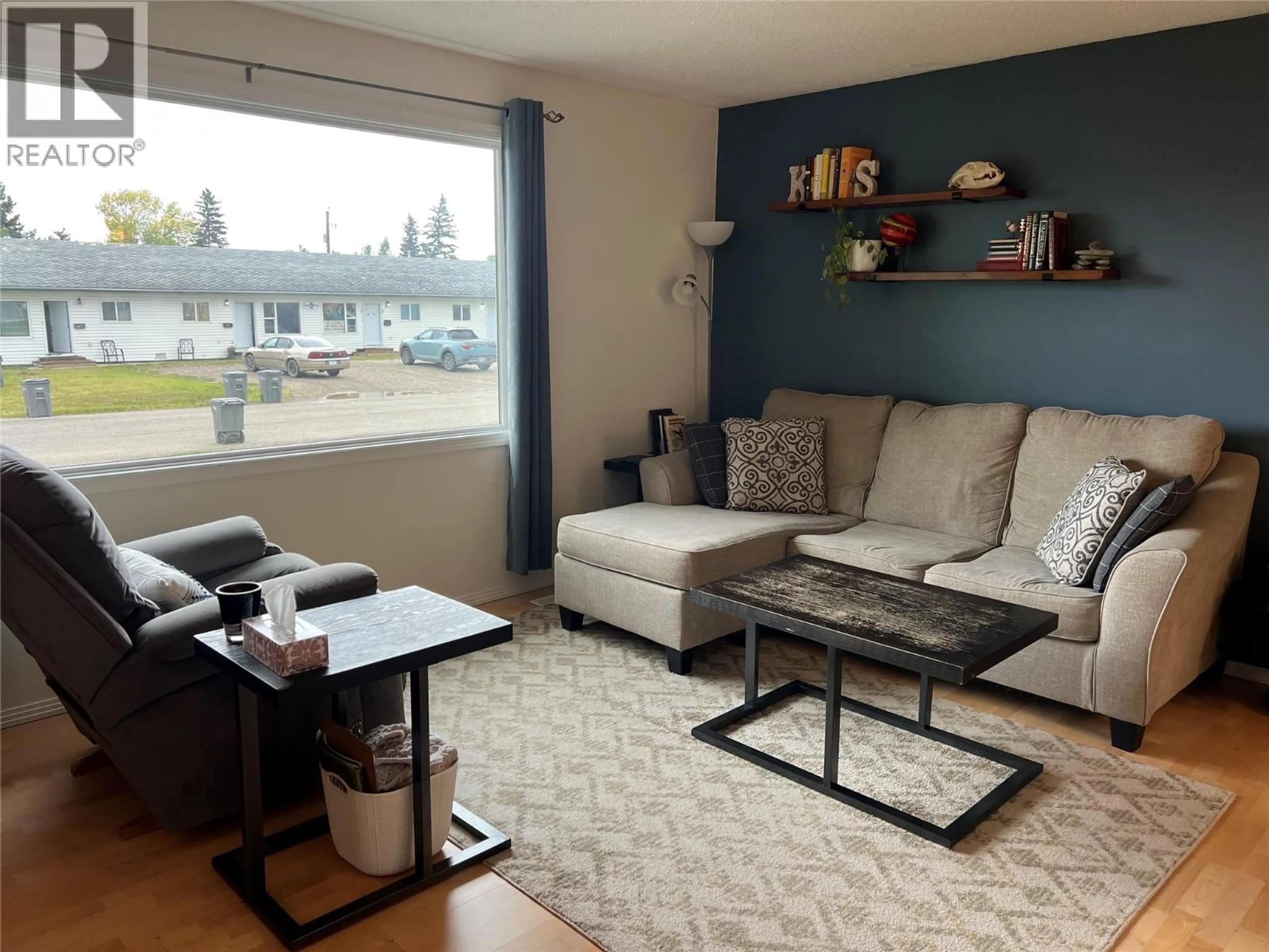Living room with furniture, wood/laminate floor for 1017 120 AVENUE, Dawson Creek British Columbia V1G3J8