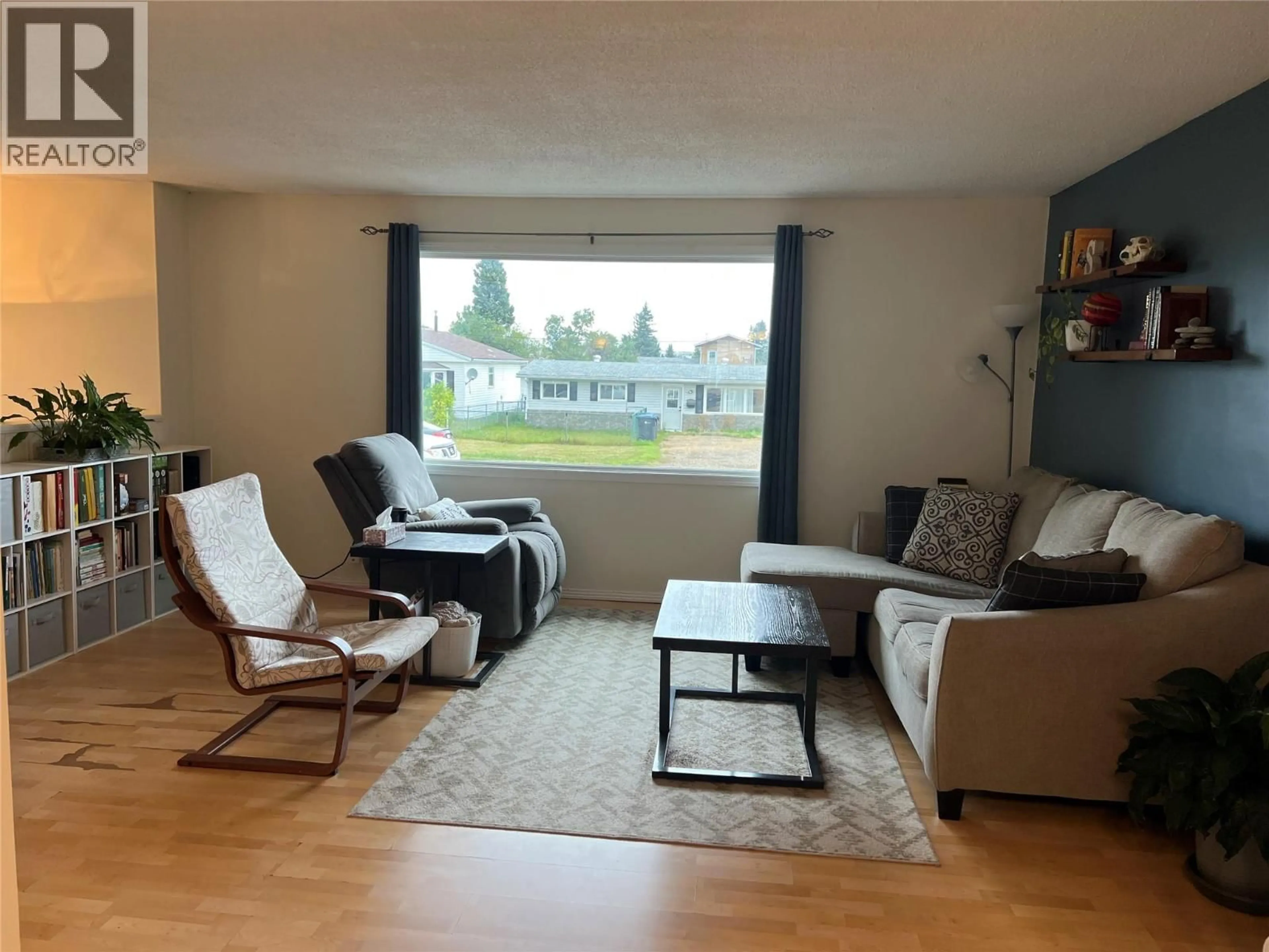 Living room with furniture, wood/laminate floor for 1017 120 AVENUE, Dawson Creek British Columbia V1G3J8