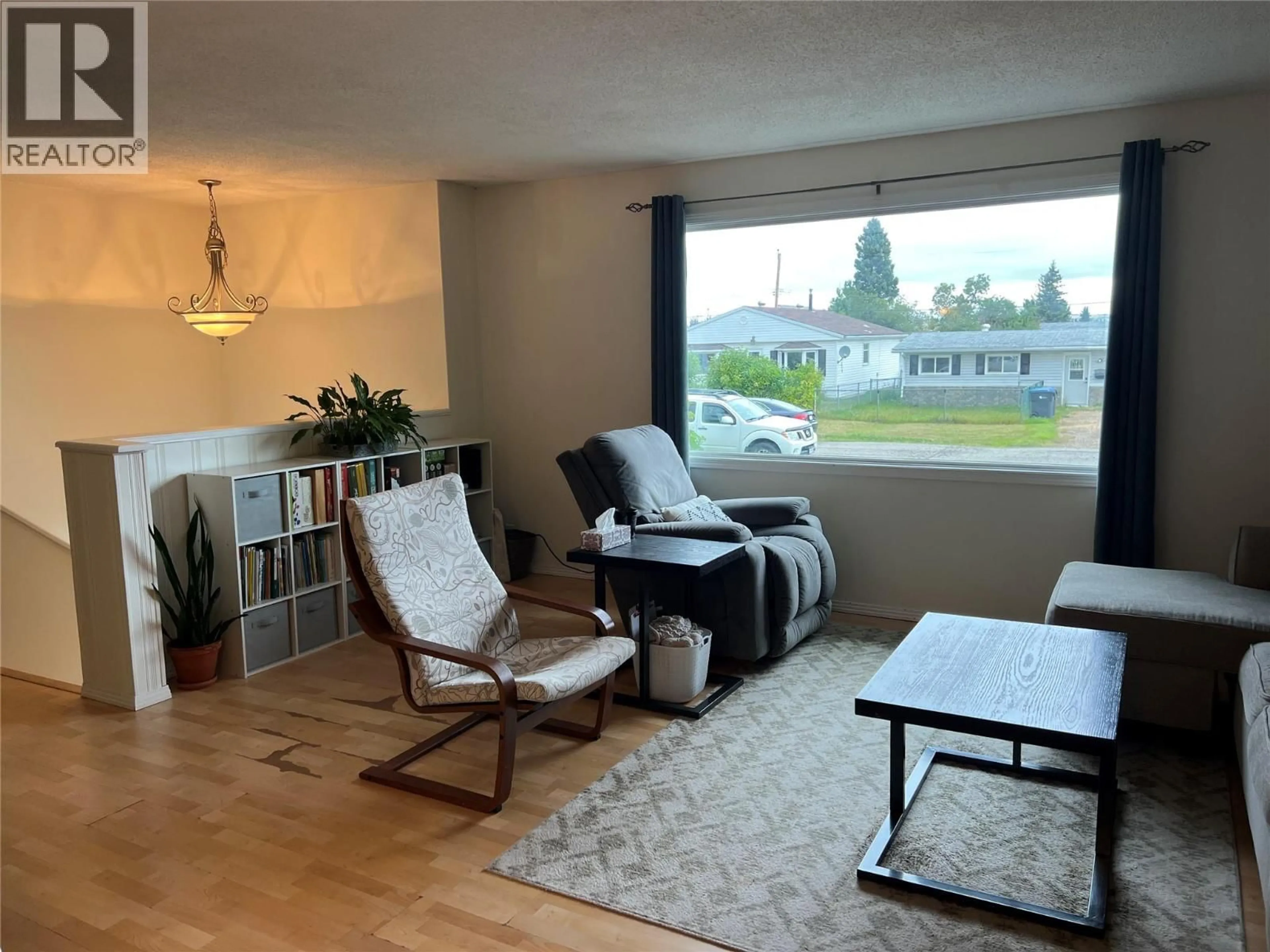 Living room with furniture, wood/laminate floor for 1017 120 AVENUE, Dawson Creek British Columbia V1G3J8