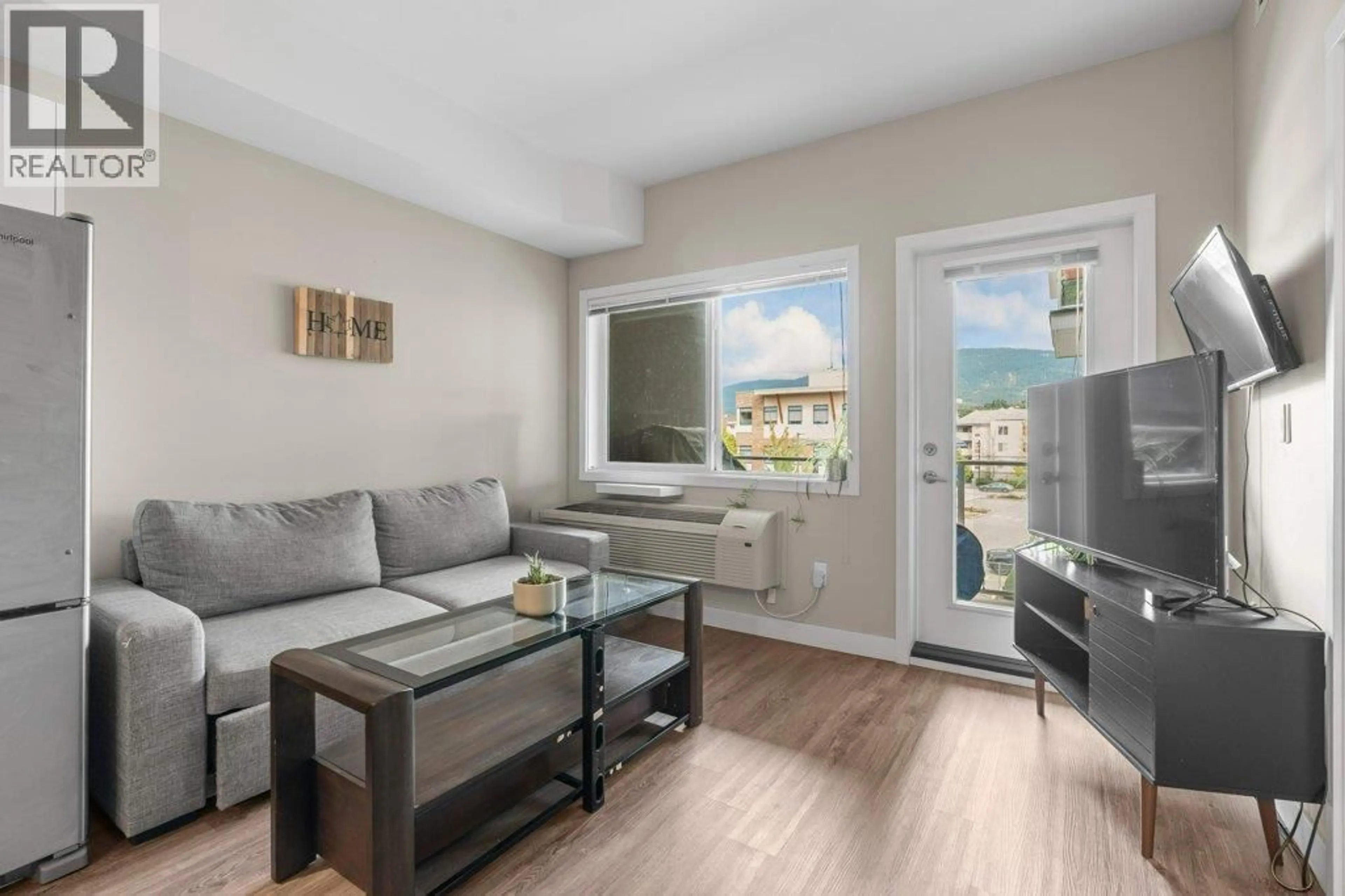 Living room with furniture, wood/laminate floor for 309 - 3409 28TH AVENUE, Vernon British Columbia V1T0B3