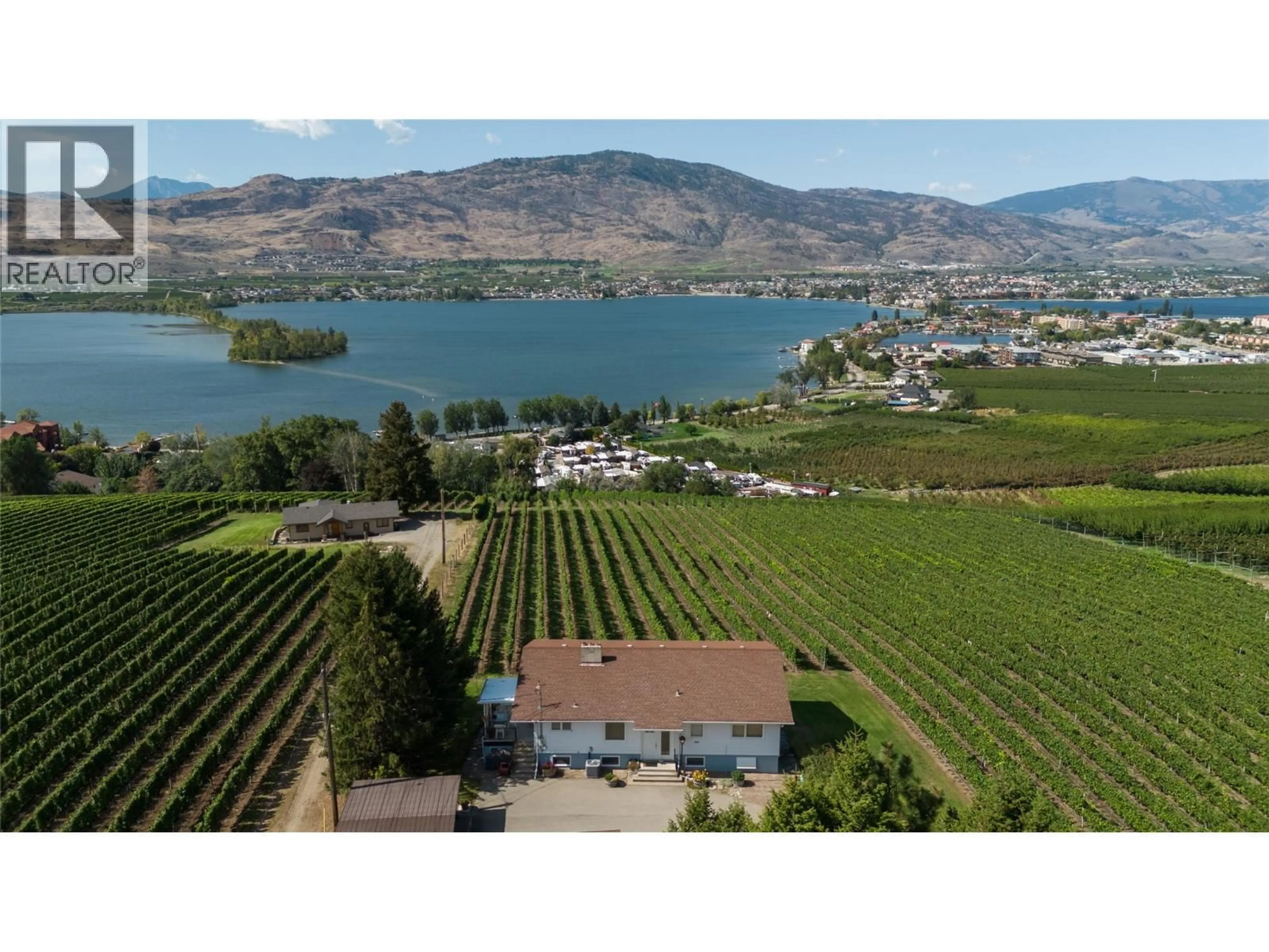 A pic from outside/outdoor area/front of a property/back of a property/a pic from drone, water/lake/river/ocean view for 5012 33RD STREET, Osoyoos British Columbia V0H1V6