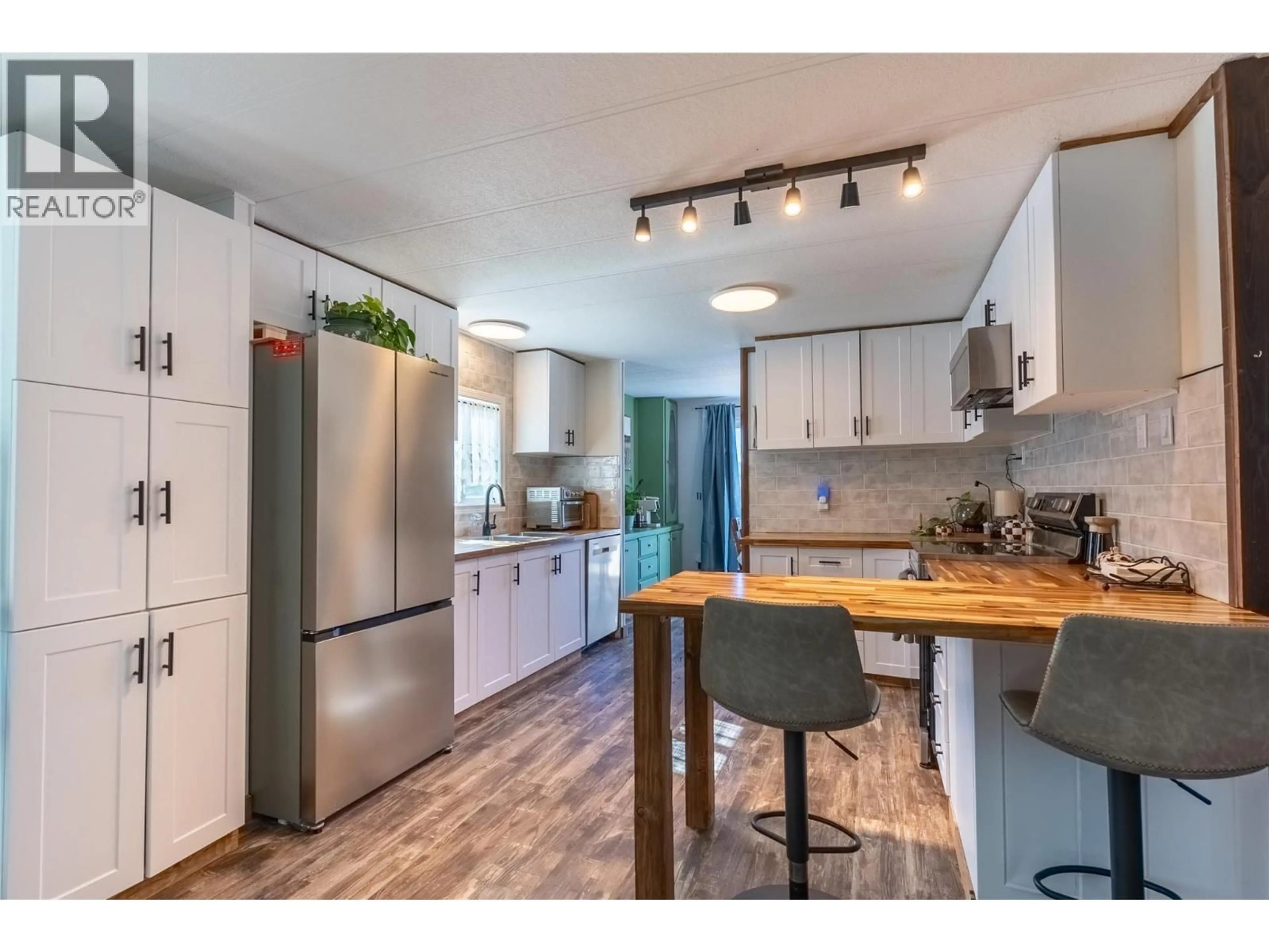 Open concept kitchen, wood/laminate floor for 99 JASPER DRIVE, Logan Lake British Columbia V0K1W0