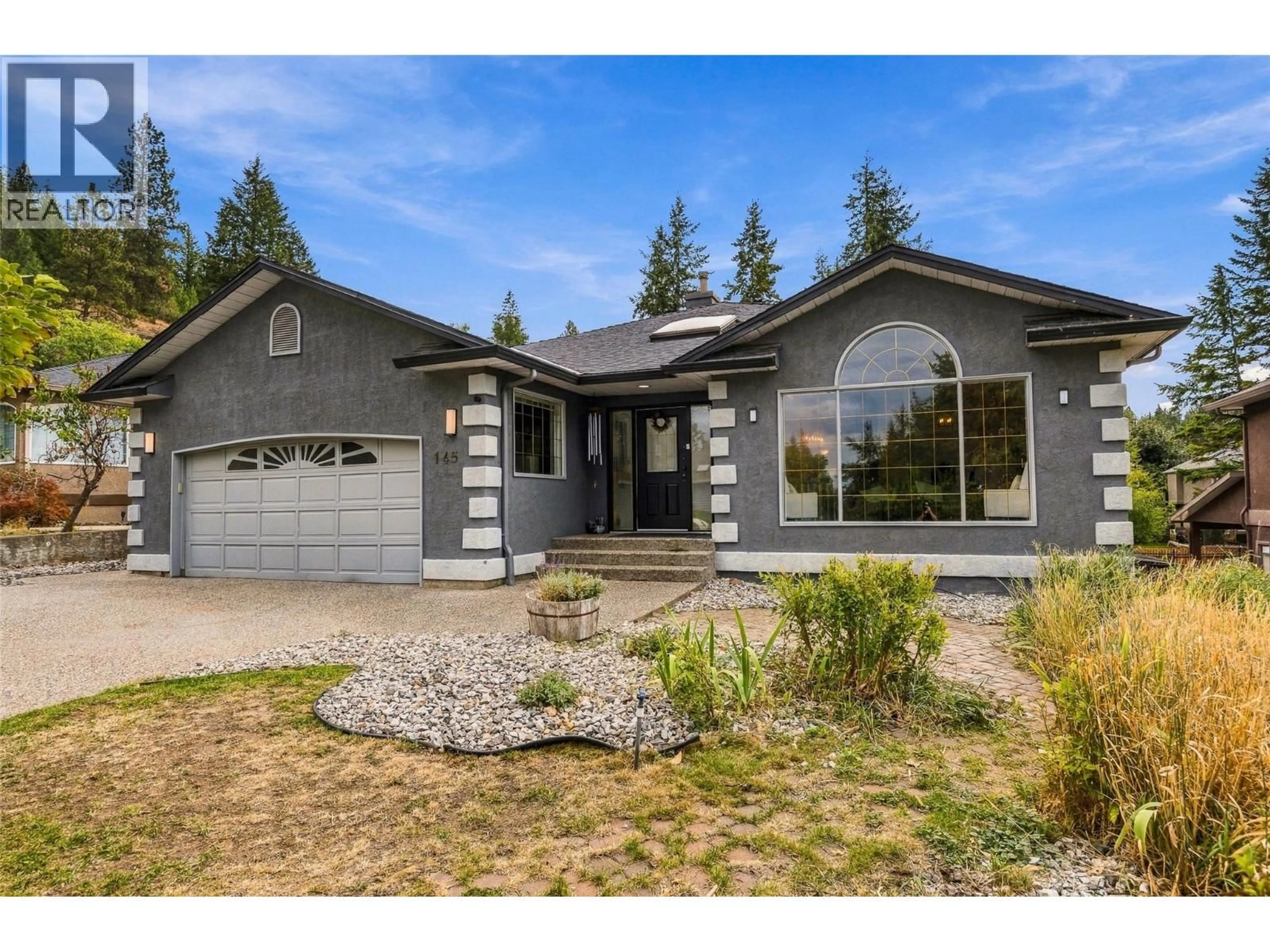 Home with vinyl exterior material, street for 145 MAGIC DRIVE, Kelowna British Columbia V1V1N2