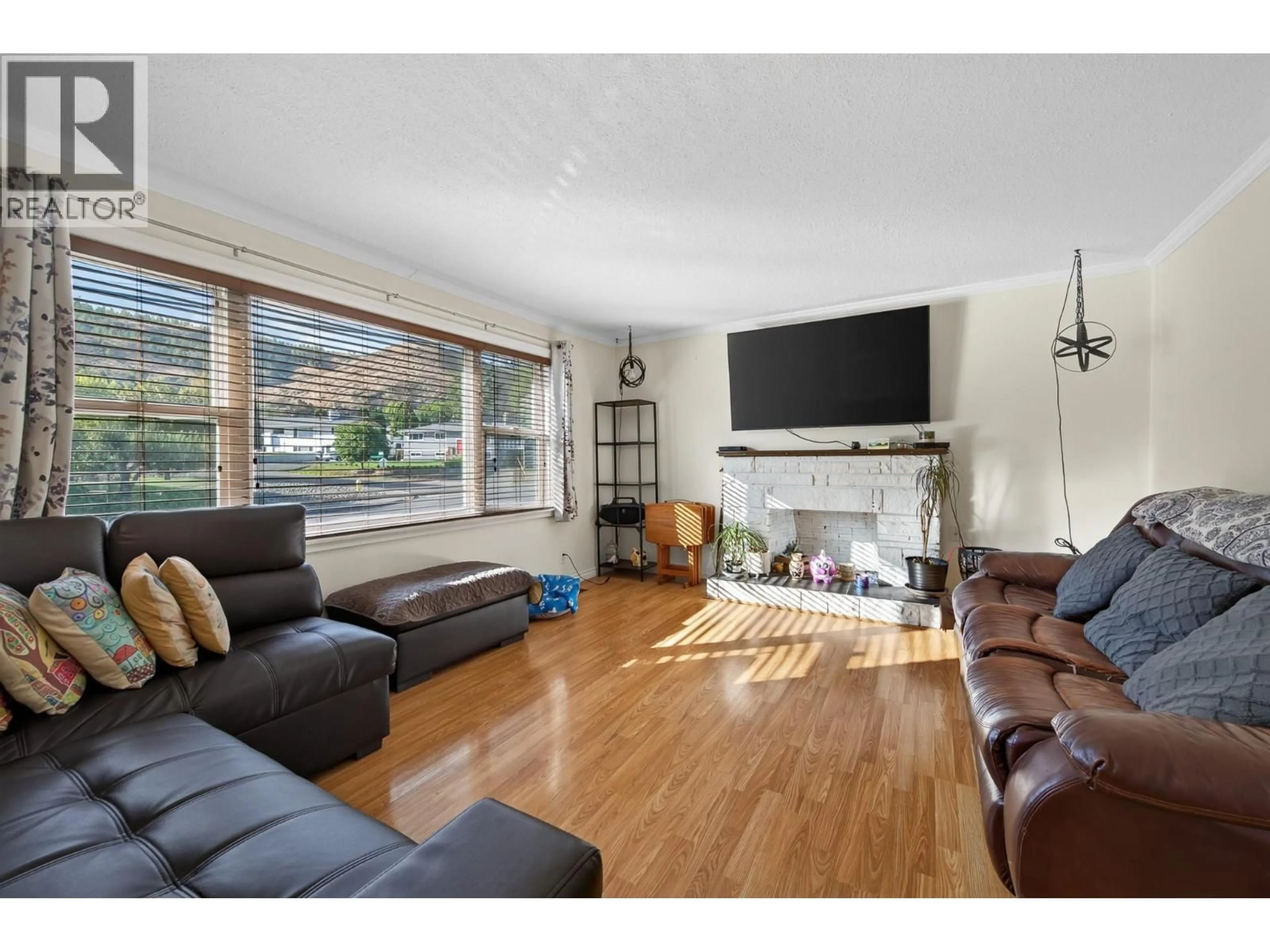 Living room with furniture, wood/laminate floor for 3575 WESTSYDE ROAD, Kamloops British Columbia V2B7H5