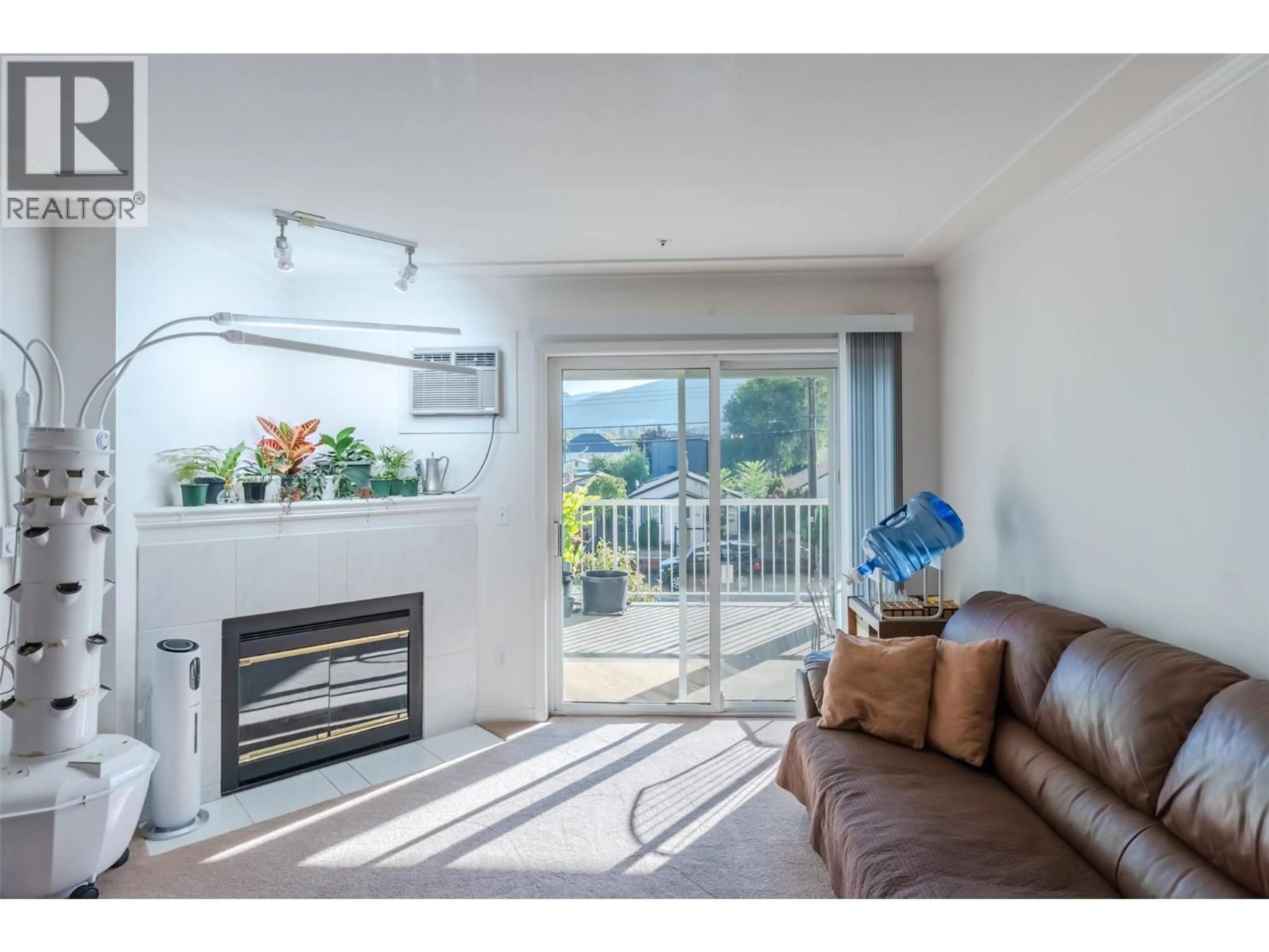 Living room with furniture, wood/laminate floor for 210 - 329 RIGSBY STREET, Penticton British Columbia V2A5S6