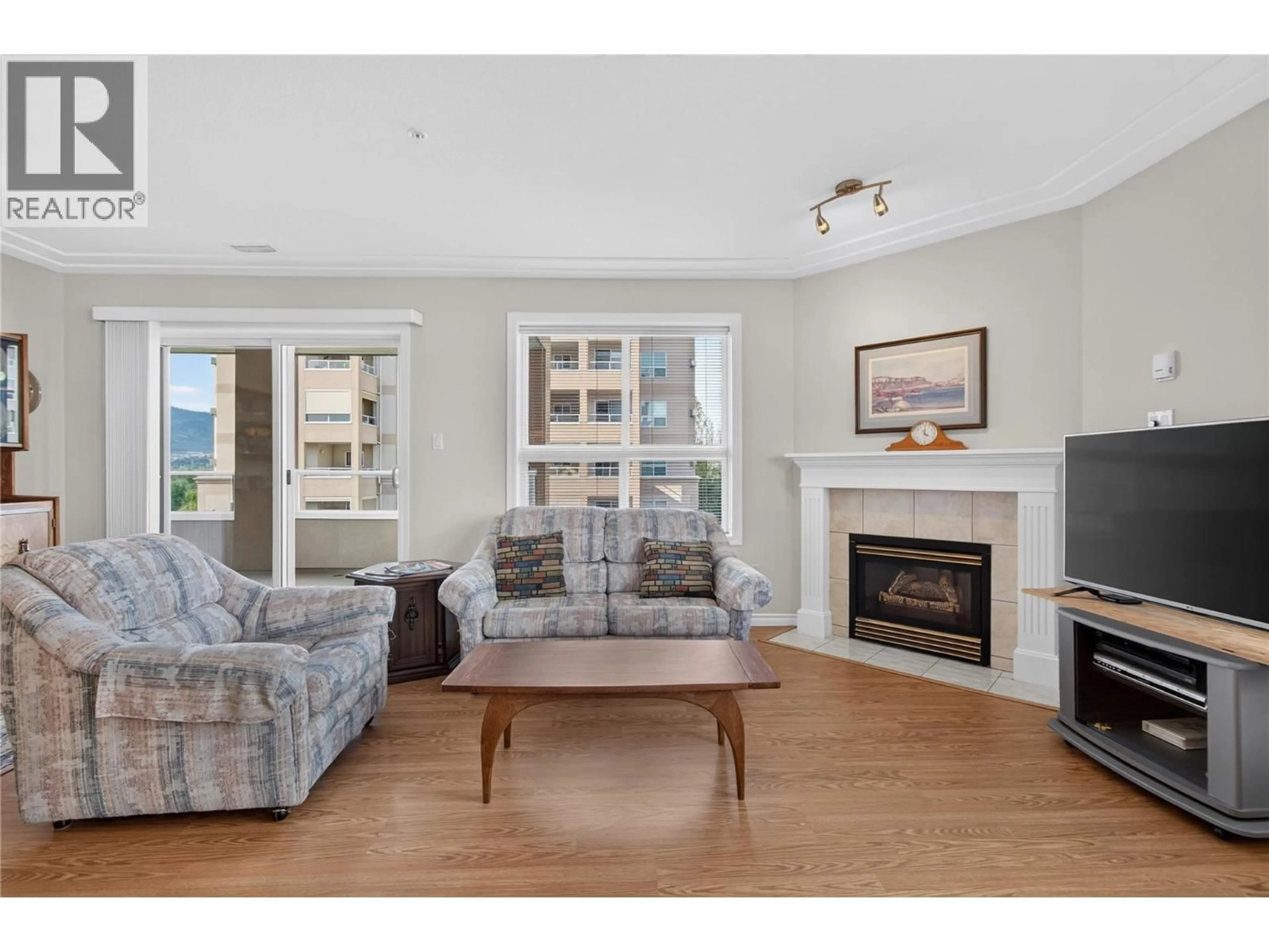 Living room with furniture, wood/laminate floor for 506 - 2285 ATKINSON STREET, Penticton British Columbia V2A8R7