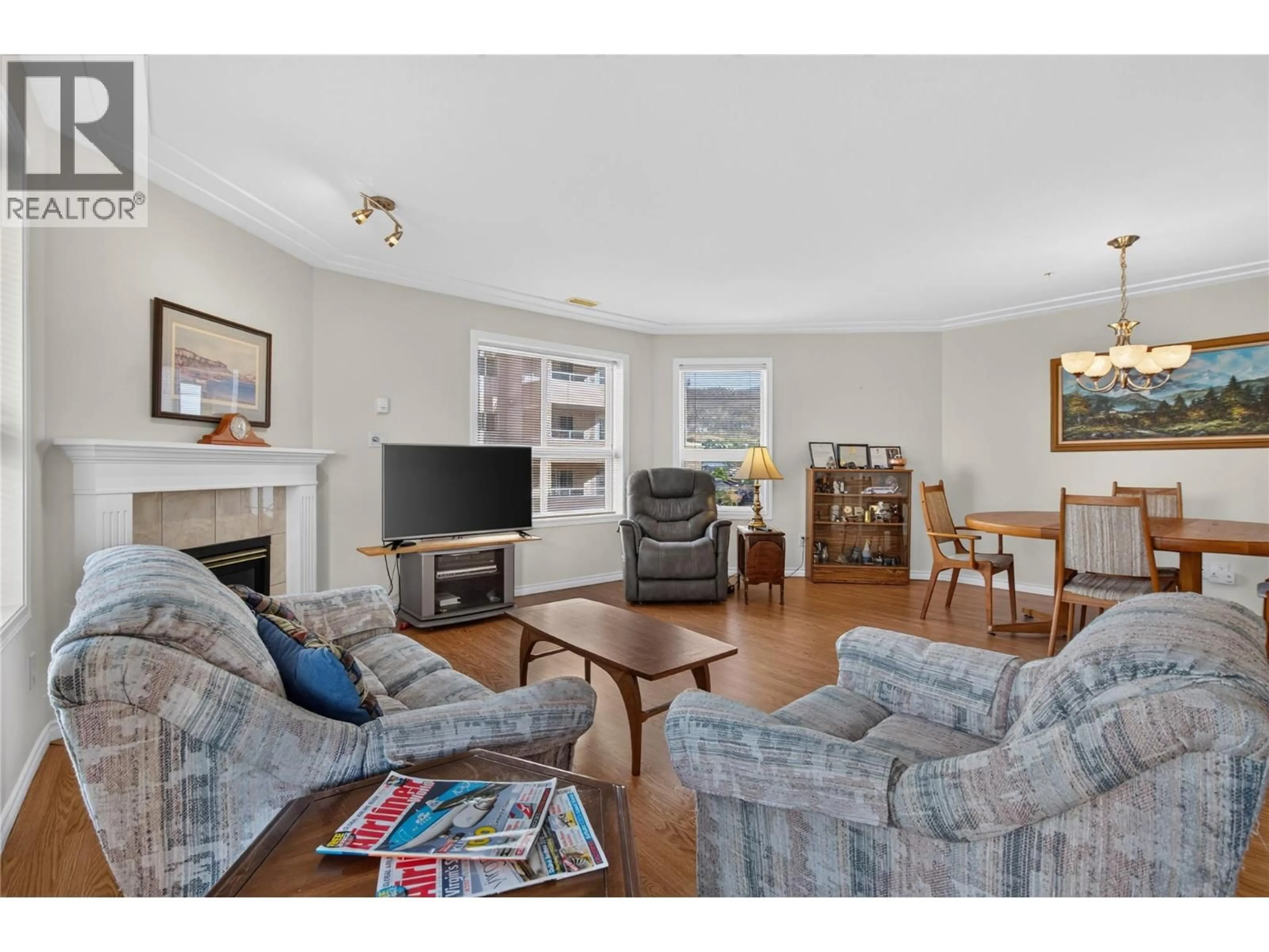 Living room with furniture, wood/laminate floor for 506 - 2285 ATKINSON STREET, Penticton British Columbia V2A8R7