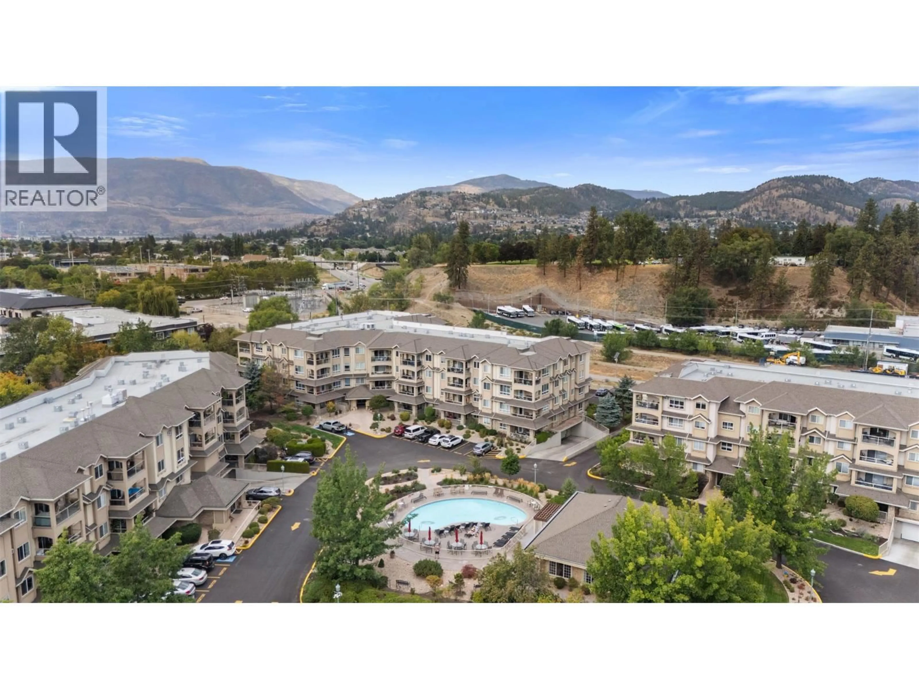 A pic from outside/outdoor area/front of a property/back of a property/a pic from drone, mountain view for 105 - 1960 ENTERPRISE WAY, Kelowna British Columbia V1Y9S5