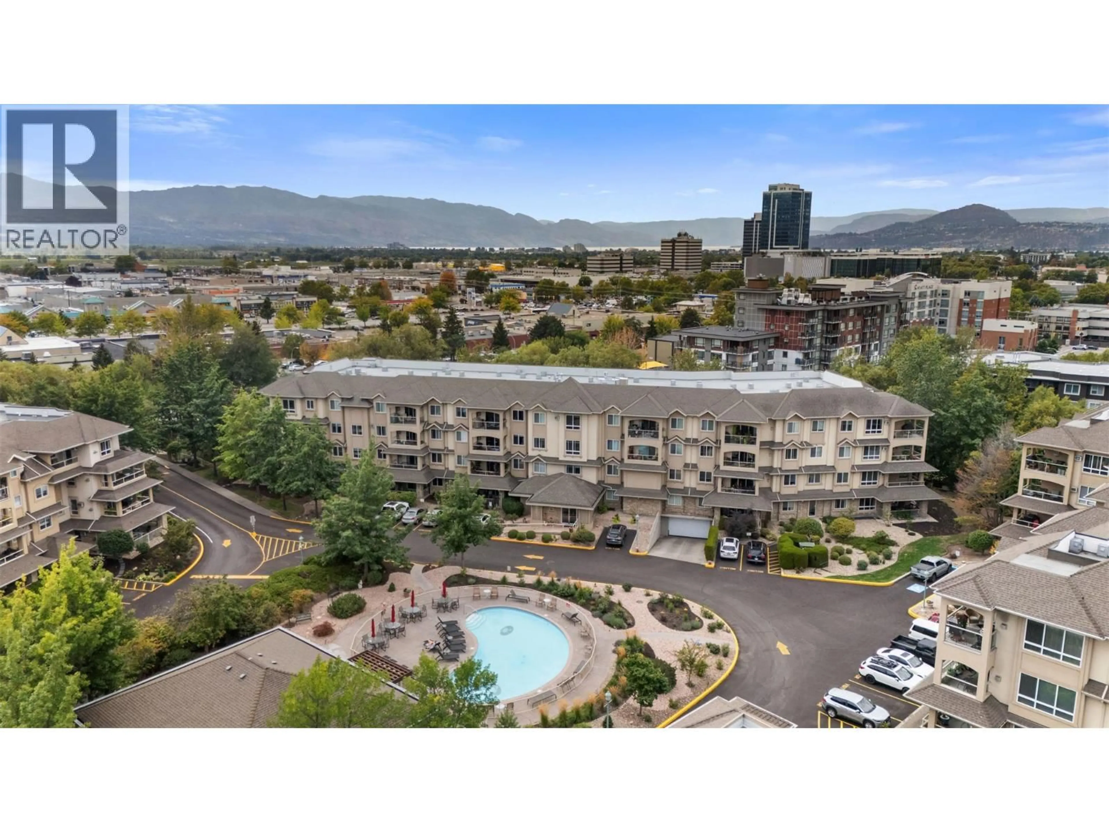 A pic from outside/outdoor area/front of a property/back of a property/a pic from drone, mountain view for 105 - 1960 ENTERPRISE WAY, Kelowna British Columbia V1Y9S5
