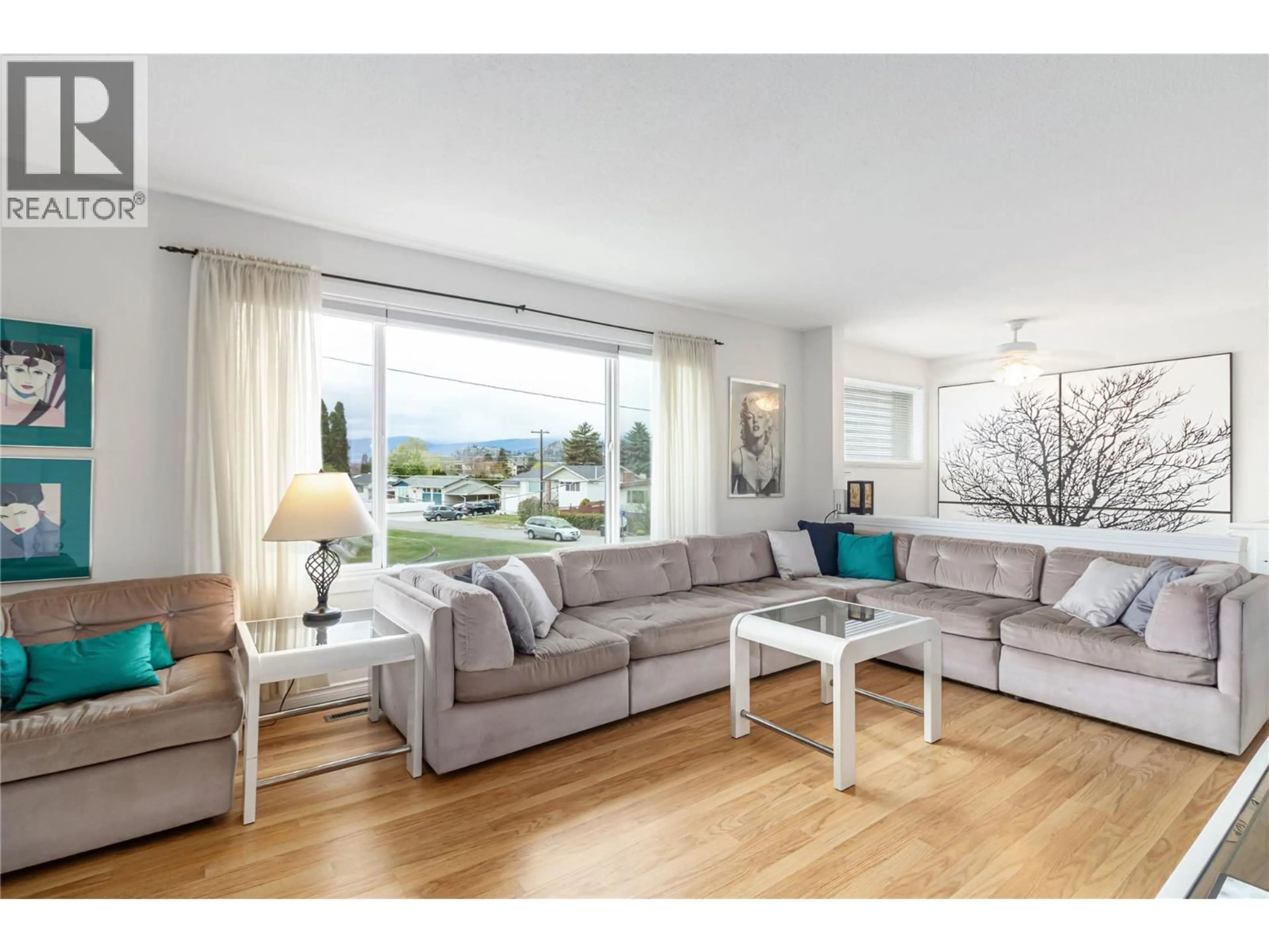 Living room with furniture, wood/laminate floor for 285 DELL ROAD, Kelowna British Columbia V1X3P5