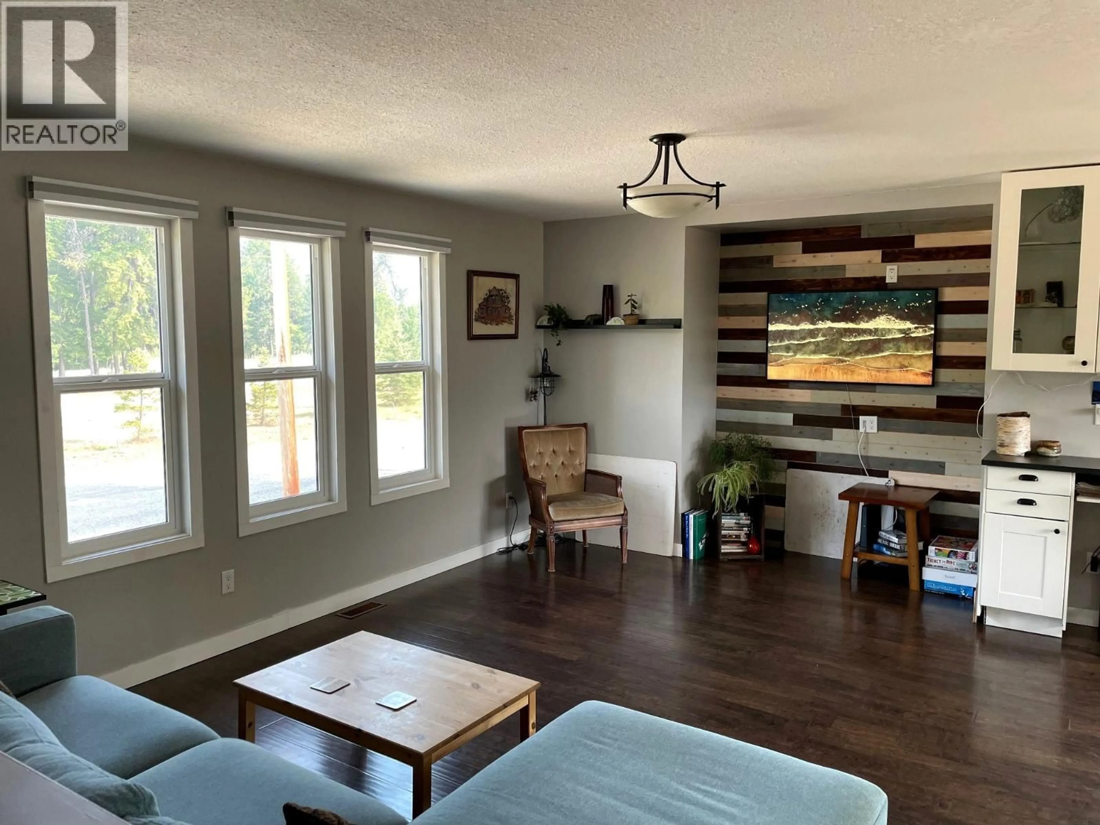 Living room with furniture, wood/laminate floor for 218 10TH AVENUE NORTHWEST, Nakusp British Columbia V0G1R0