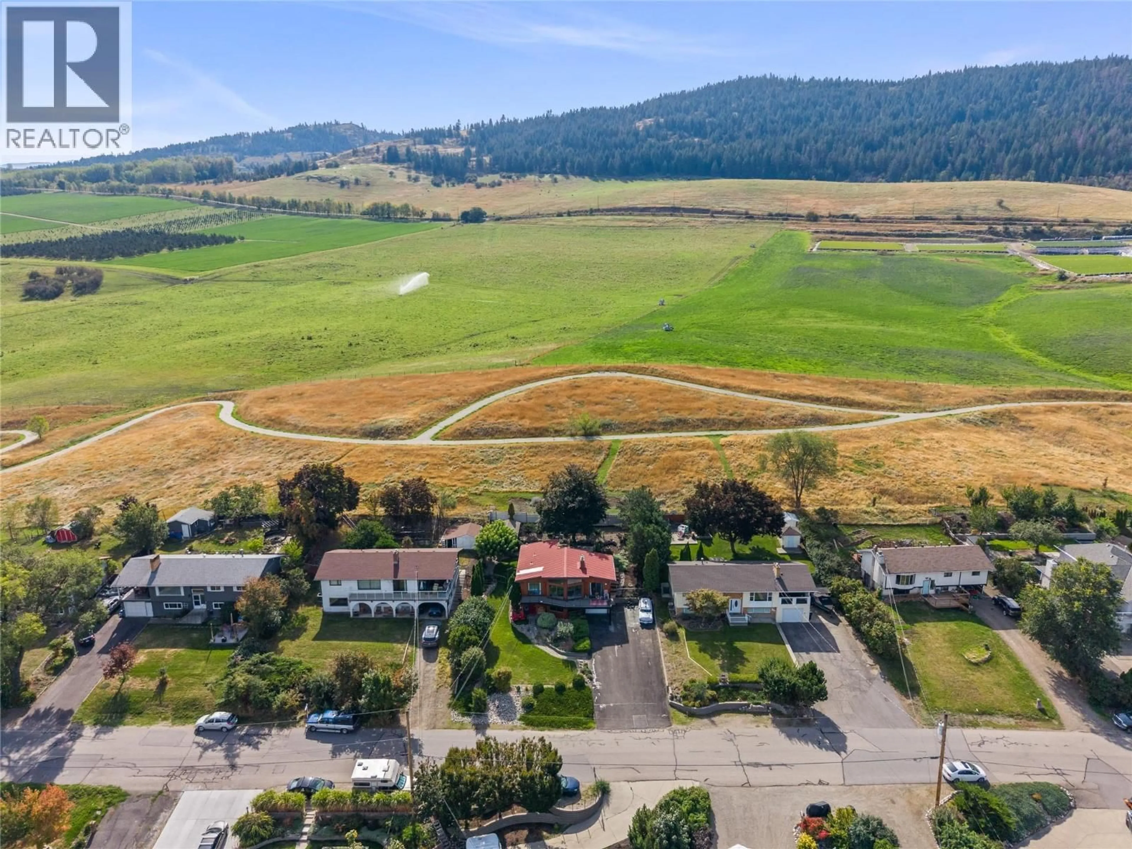 A pic from outside/outdoor area/front of a property/back of a property/a pic from drone, mountain view for 7108 LONGACRE DRIVE, Vernon British Columbia V1H1H6