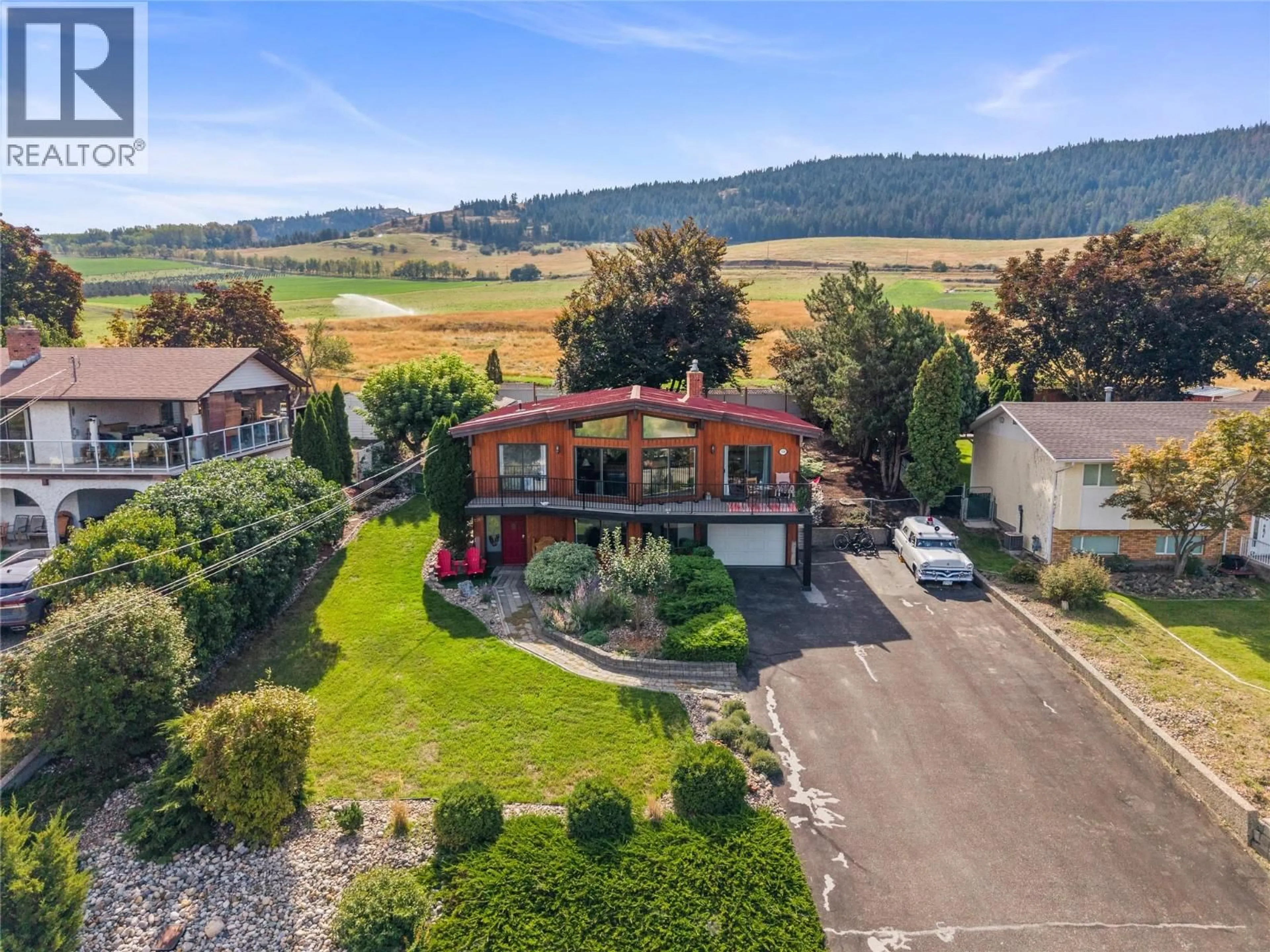 A pic from outside/outdoor area/front of a property/back of a property/a pic from drone, mountain view for 7108 LONGACRE DRIVE, Vernon British Columbia V1H1H6